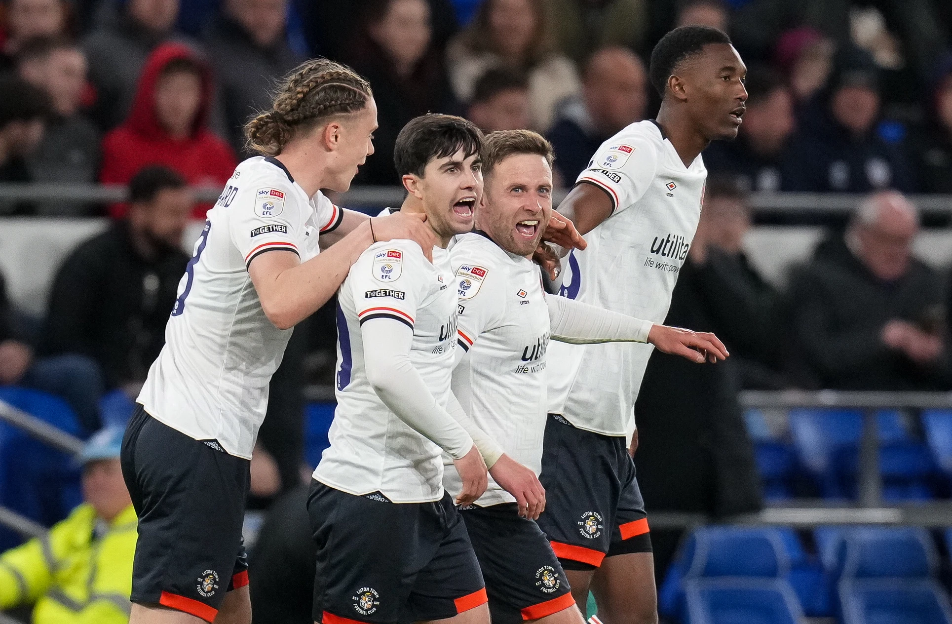 Jordan Clark is congratulated on his equalising goal at Cardiff by Thelo Aasgaard, Liam Walsh and Christ Makosso.