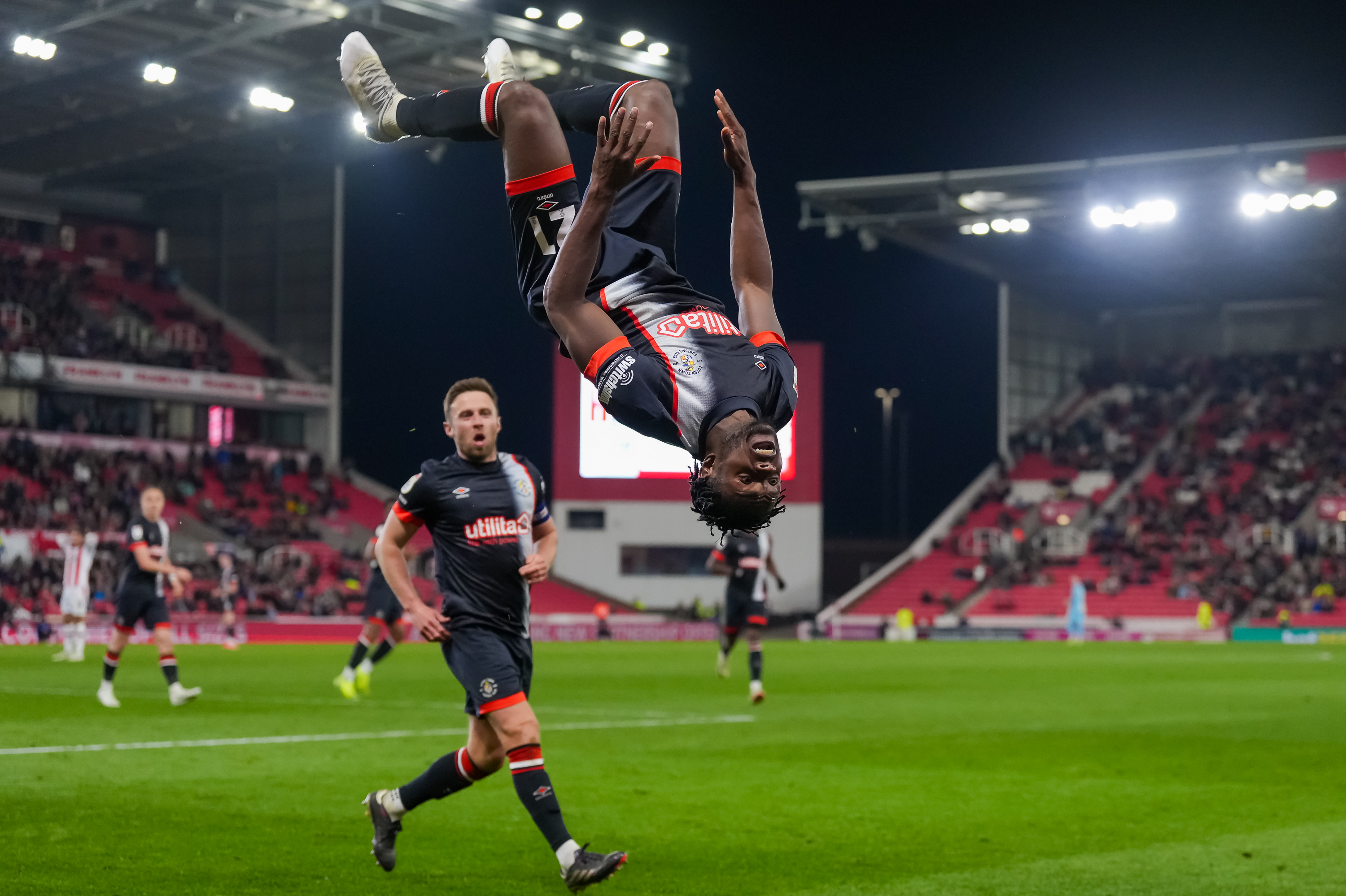 Milli Alli flips in the air as he launches his trademark somersault celebration after netting the equaliser in the 1-1 draw at Stoke.