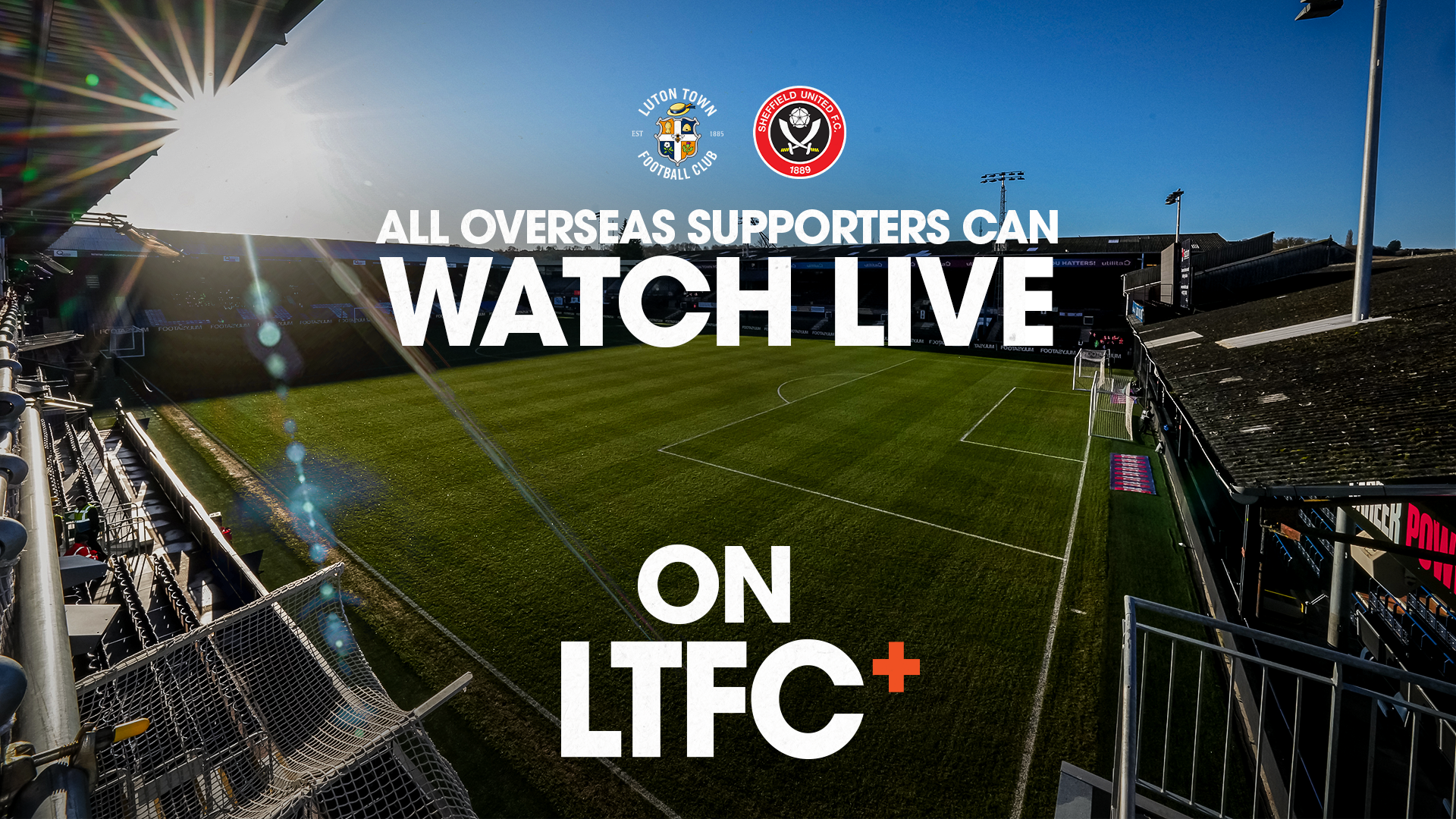 A graphic showing that LTFC+ is available all over the world over a backdrop of Kenilworth Road stadium, with the sun shining brightly.