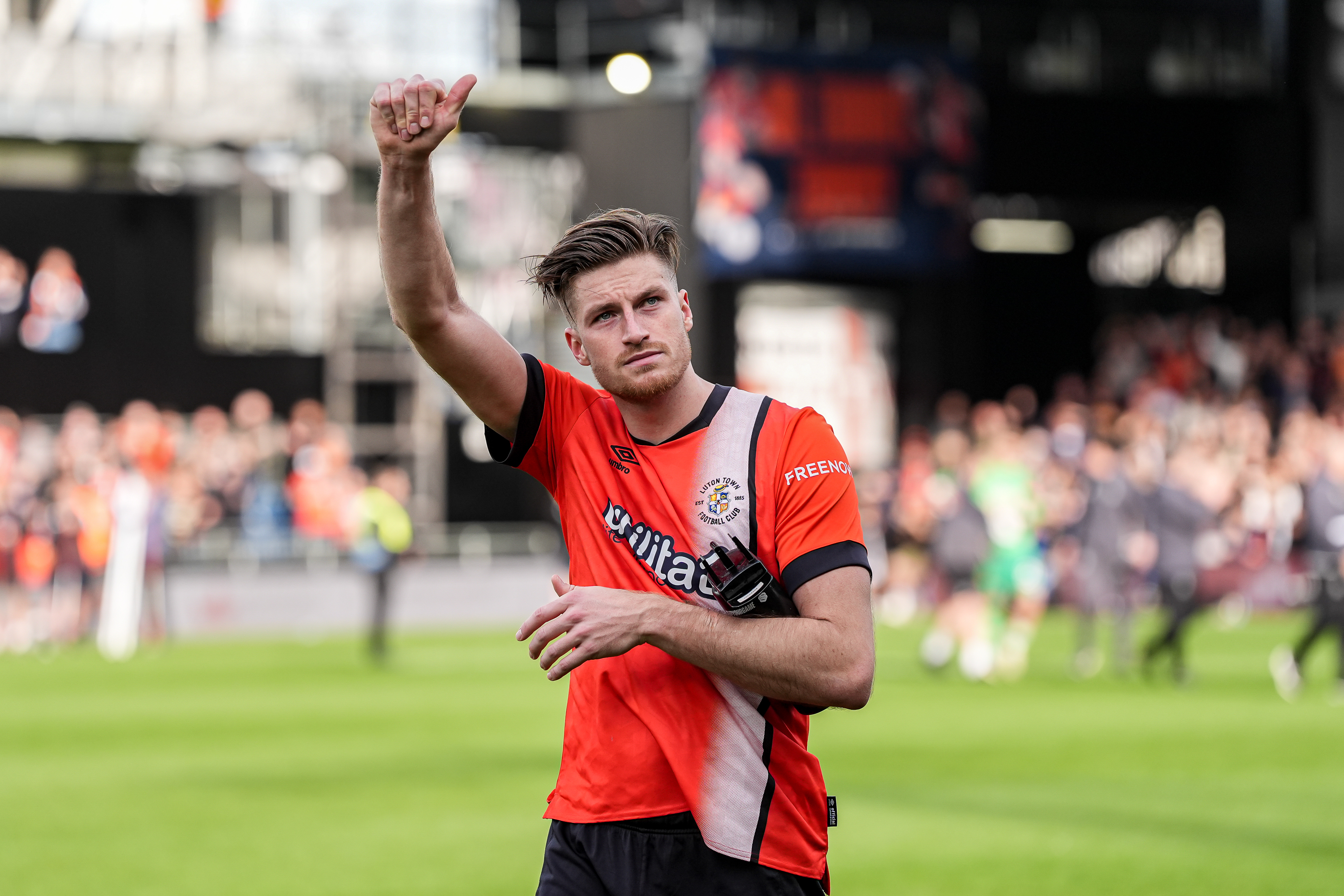 Reece Burke acknowledges the Kenilworth Road crowd after the Hatters' win over Bournemouth in the Premier League.