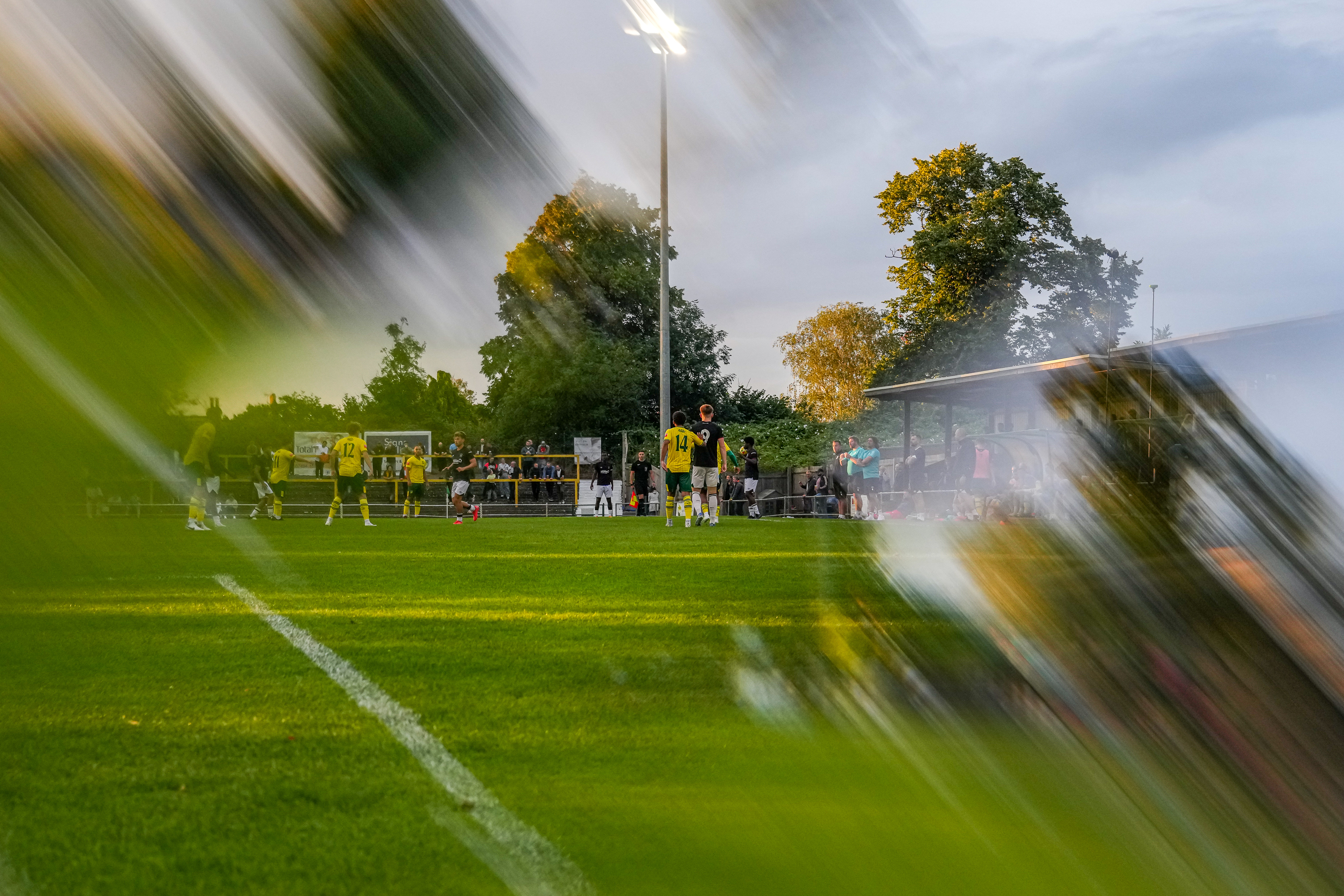 An arty landscape shot of the Hatters in action at Hitchin Town's Top Field during pre-season 2024