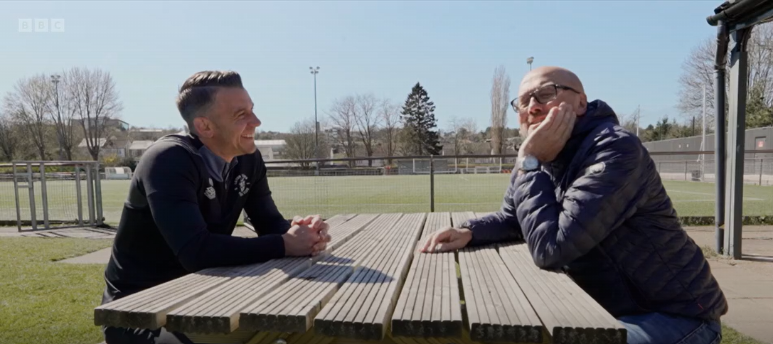 Manager Matt Bloomfield and the BBC's Mark Clemmit chat at one of the picnic tables at the Hatters' training ground, the Brache.
