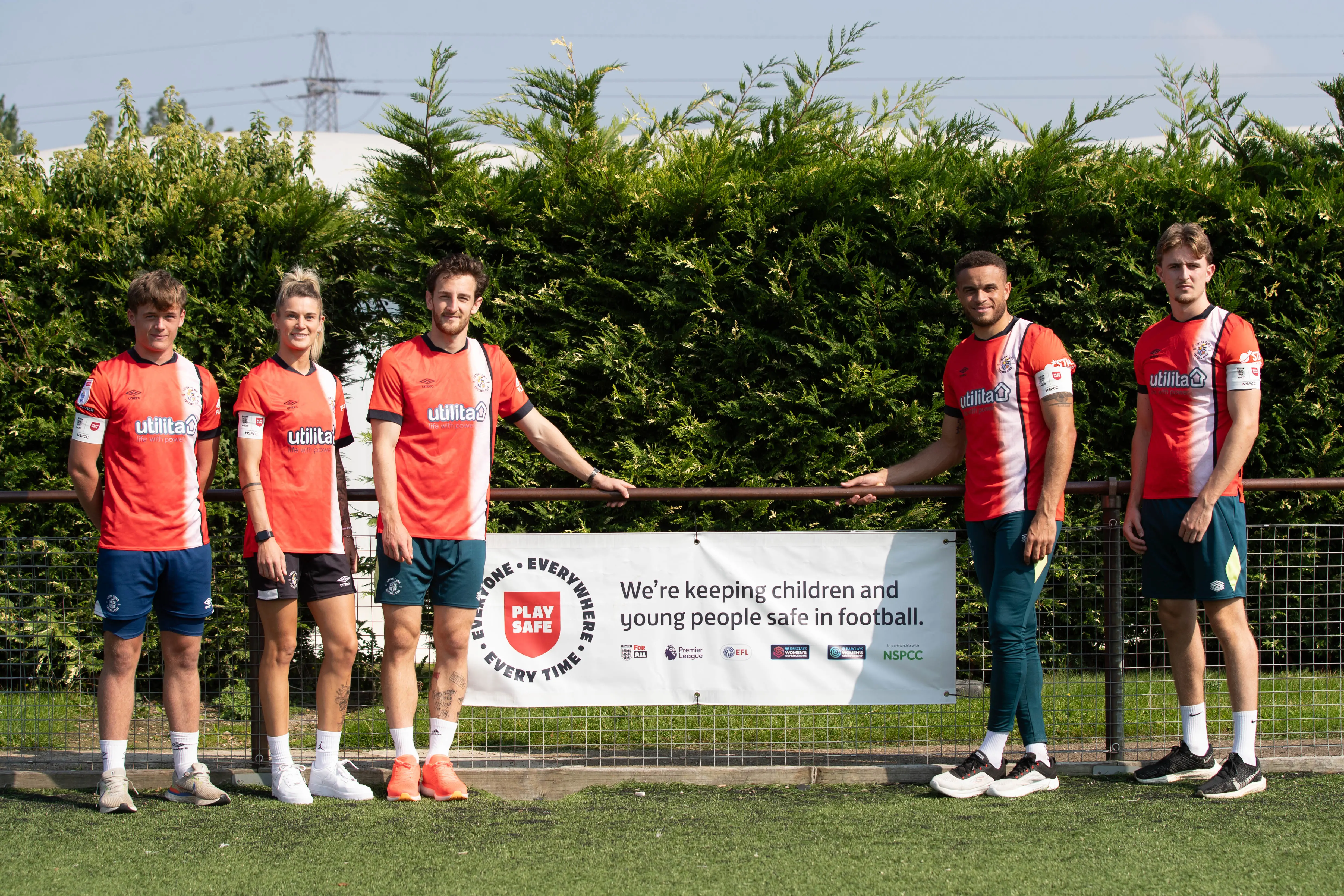 Club captain Tom Lockyer, centre, is joined by the skippers who will be wearing the 'Play Safe' armbands in fixtures this weekend: Charlie Emery (Men's U18s), Elly Wade (Luton Town Ladies), Carlton Morris (Men's First Team) and Jack Bateson (Men's U21s)