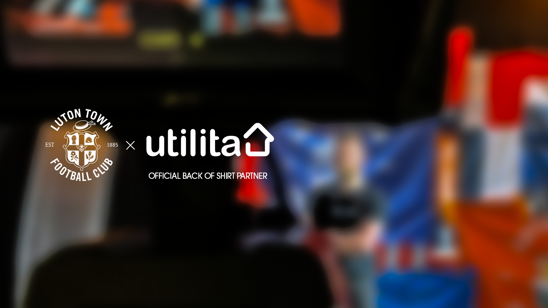 The Luton Town and Utilita logos against a backdrop of club flags and scarves to announce the new back-of-shirt partnership.