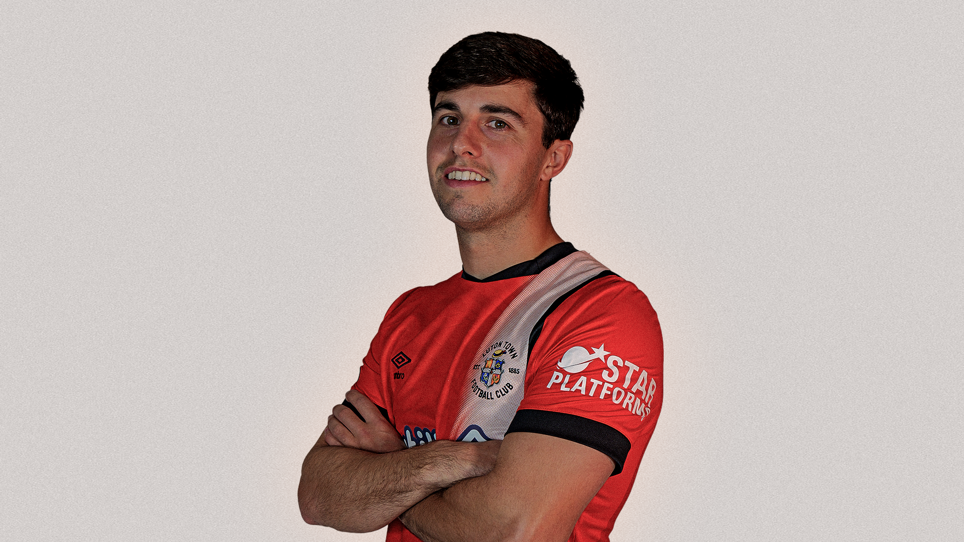 Liam Walsh pictured in the Luton Town home shirt after signing at The Brache