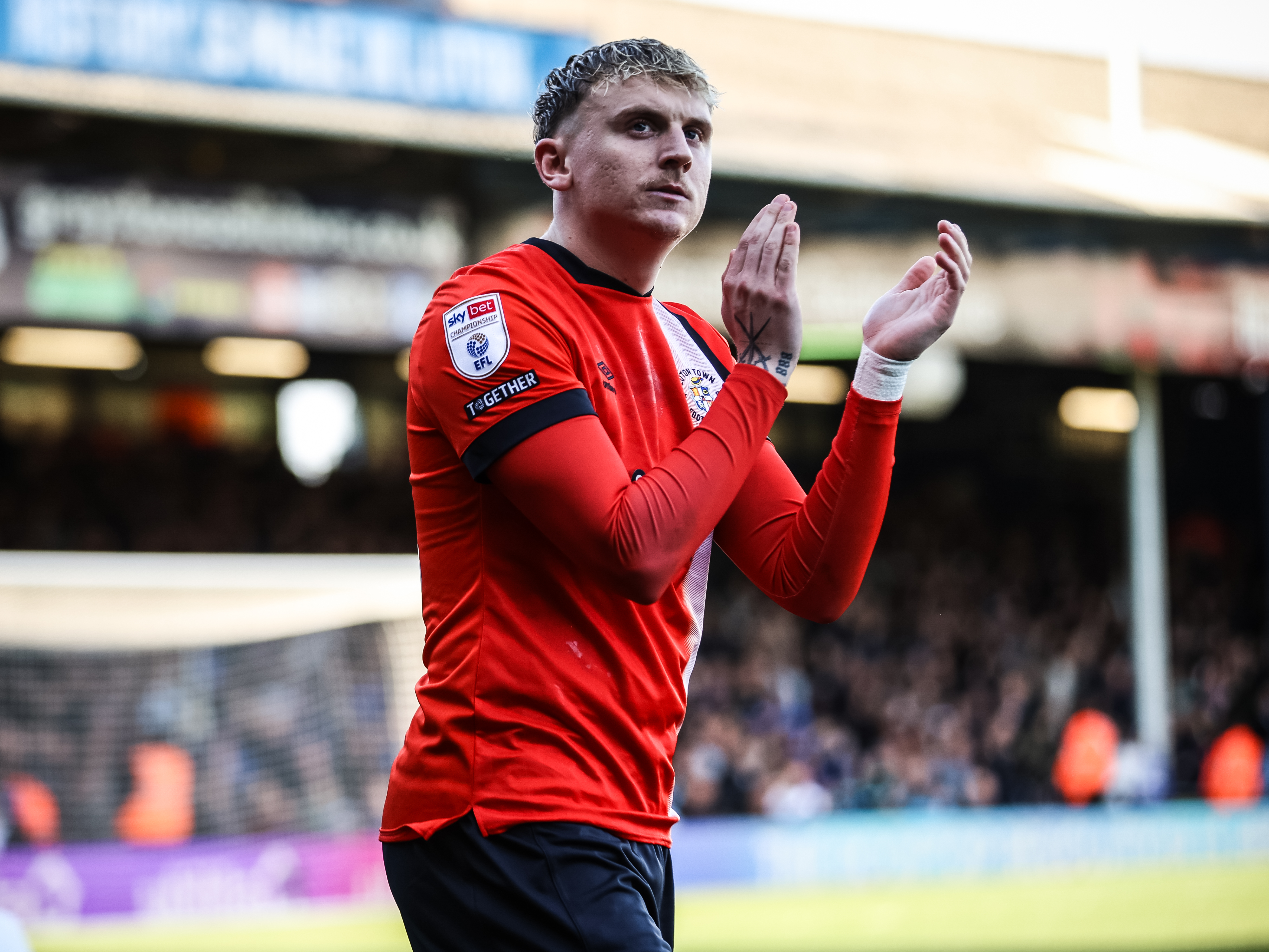 Alfie Doughty applauds the fans at Kenilworth Road.