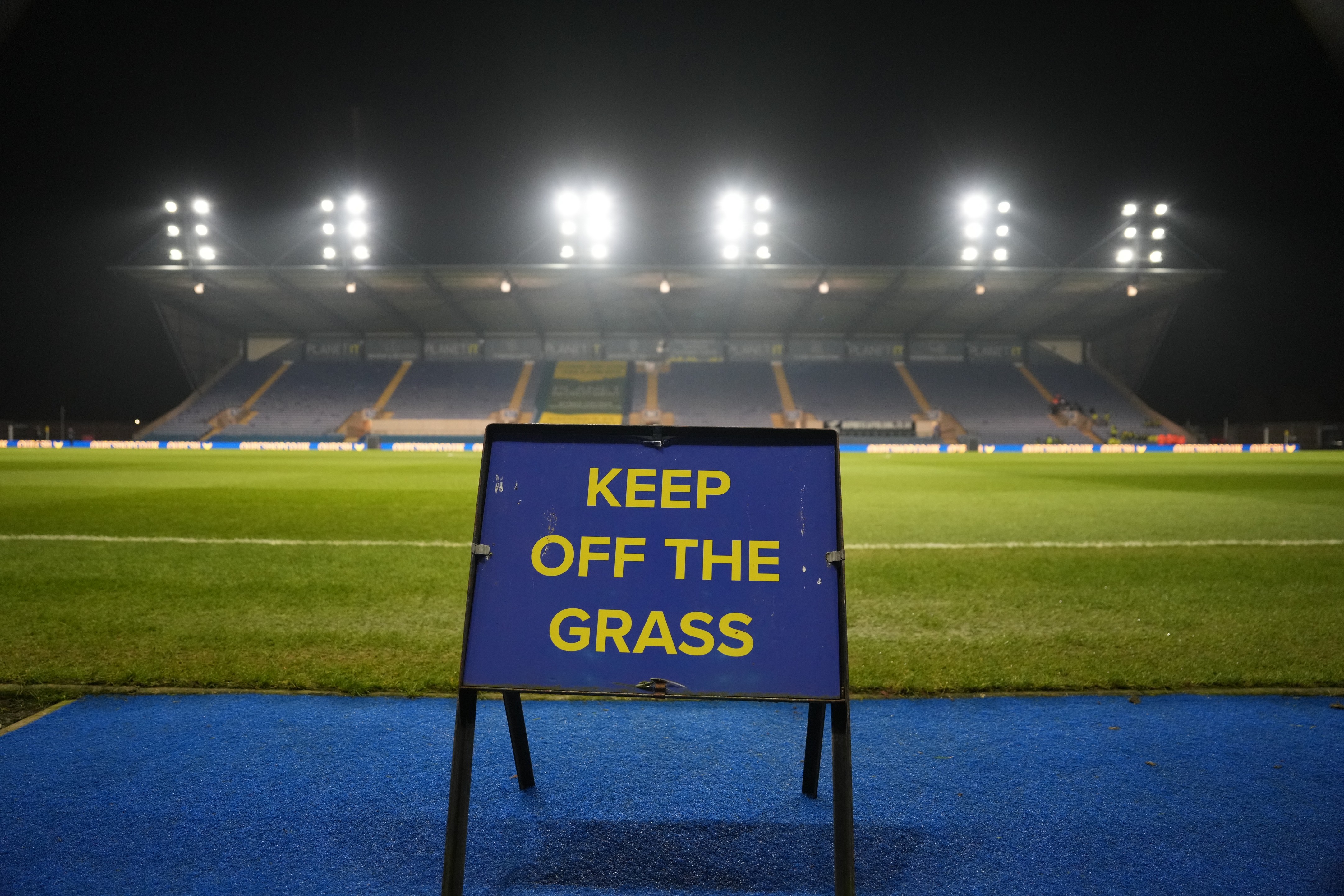 A keep off the grass sign at Kassam Stadium.