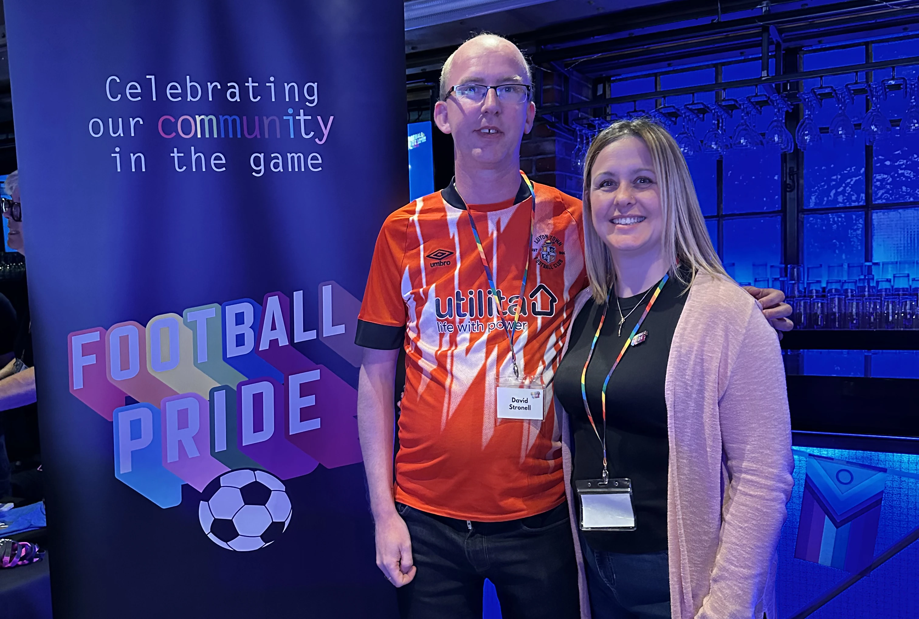 Rainbow Hatters chair David Stronell and Luton Town fan engagement officer Lisa McEvoy attend Football Pride 2024 at Stamford Bridge.