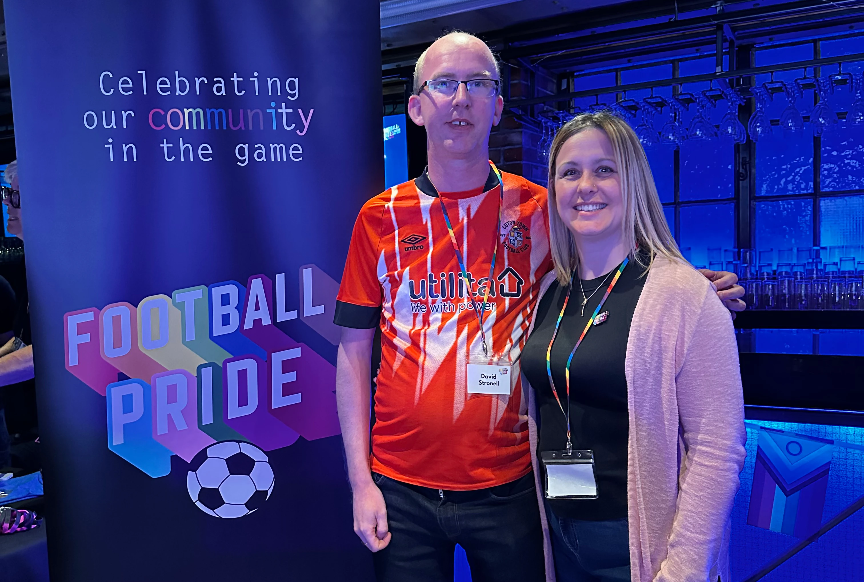Rainbow Hatters chair David Stronell and Luton Town fan engagement officer Lisa McEvoy attend Football Pride 2024 at Stamford Bridge.