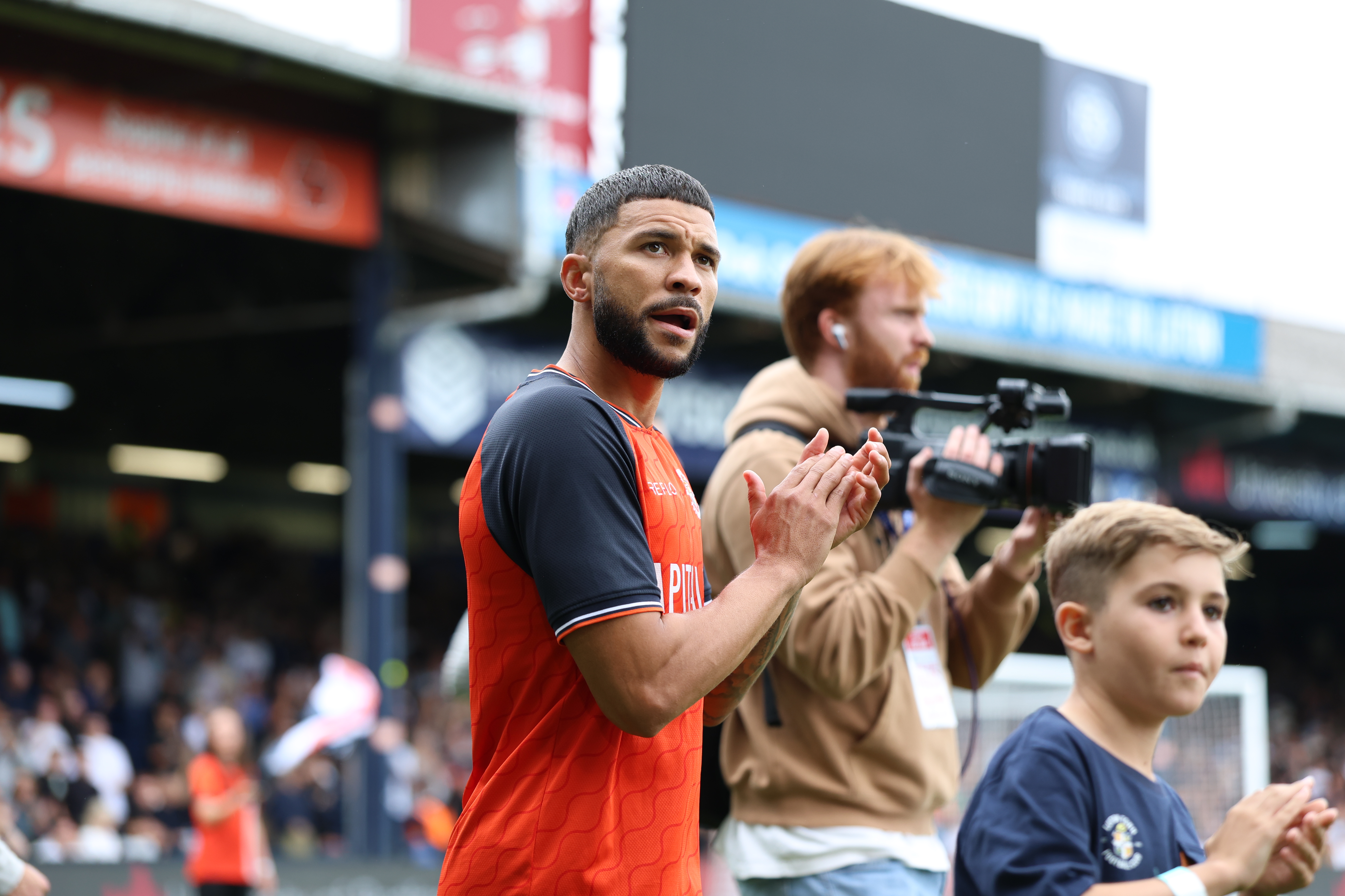 Nahki Wells applauds the Kenilworth Road crowd as he walks out for the first time as a Luton Town player.
