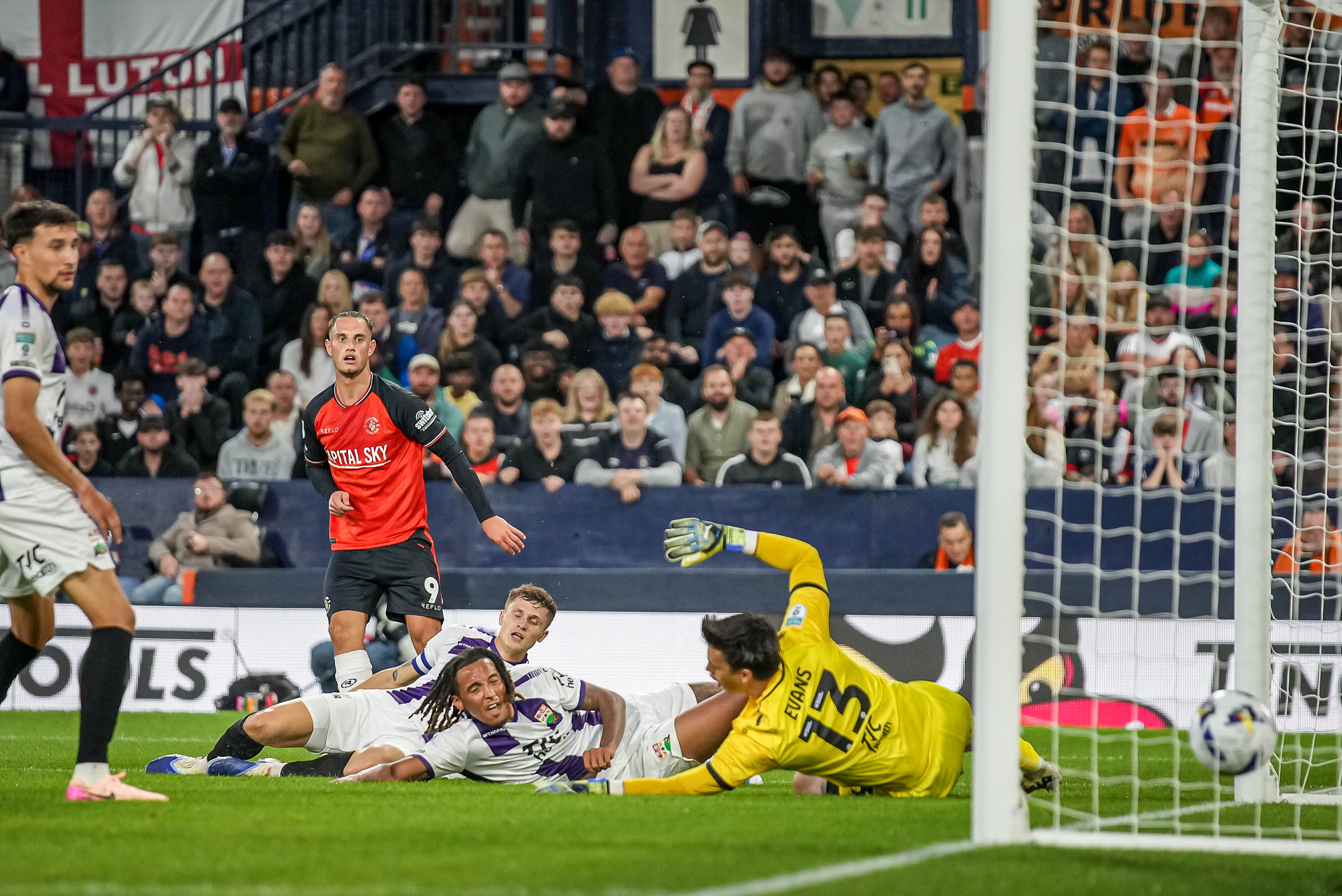 The Barnet defenders slide in but can't prevent Jerry Yates scoring his first Luton goal in the 4-1 Vertu Trophy win at Kenilworth Road.