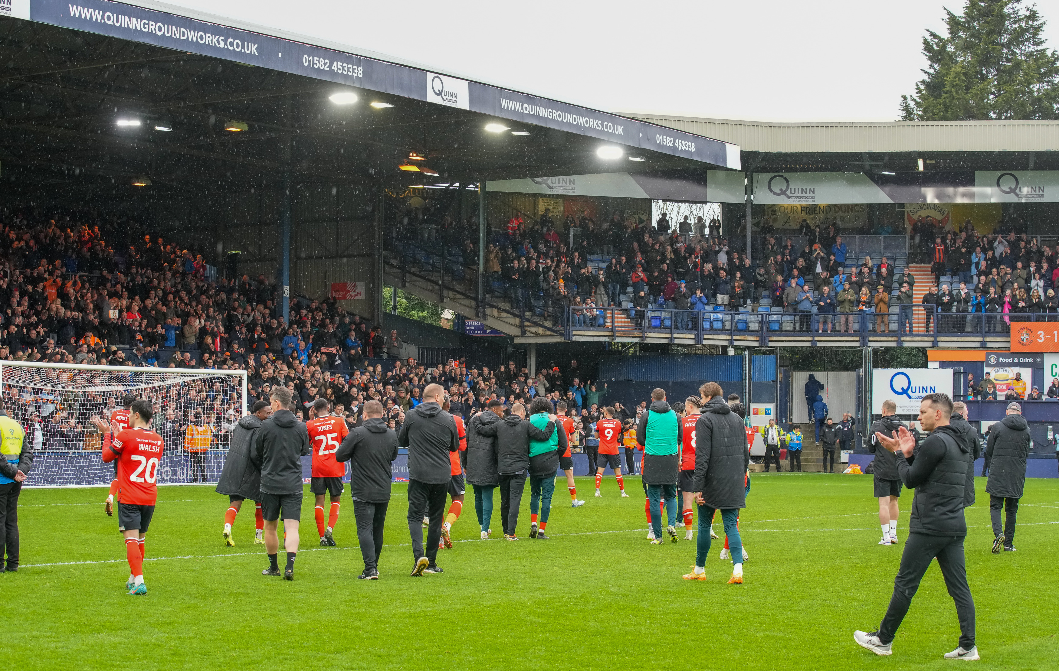 The Hatters players and staff applaud the crowd during their lap of appreciation after beating Bristol City 3-1 at Kenilworth Road.