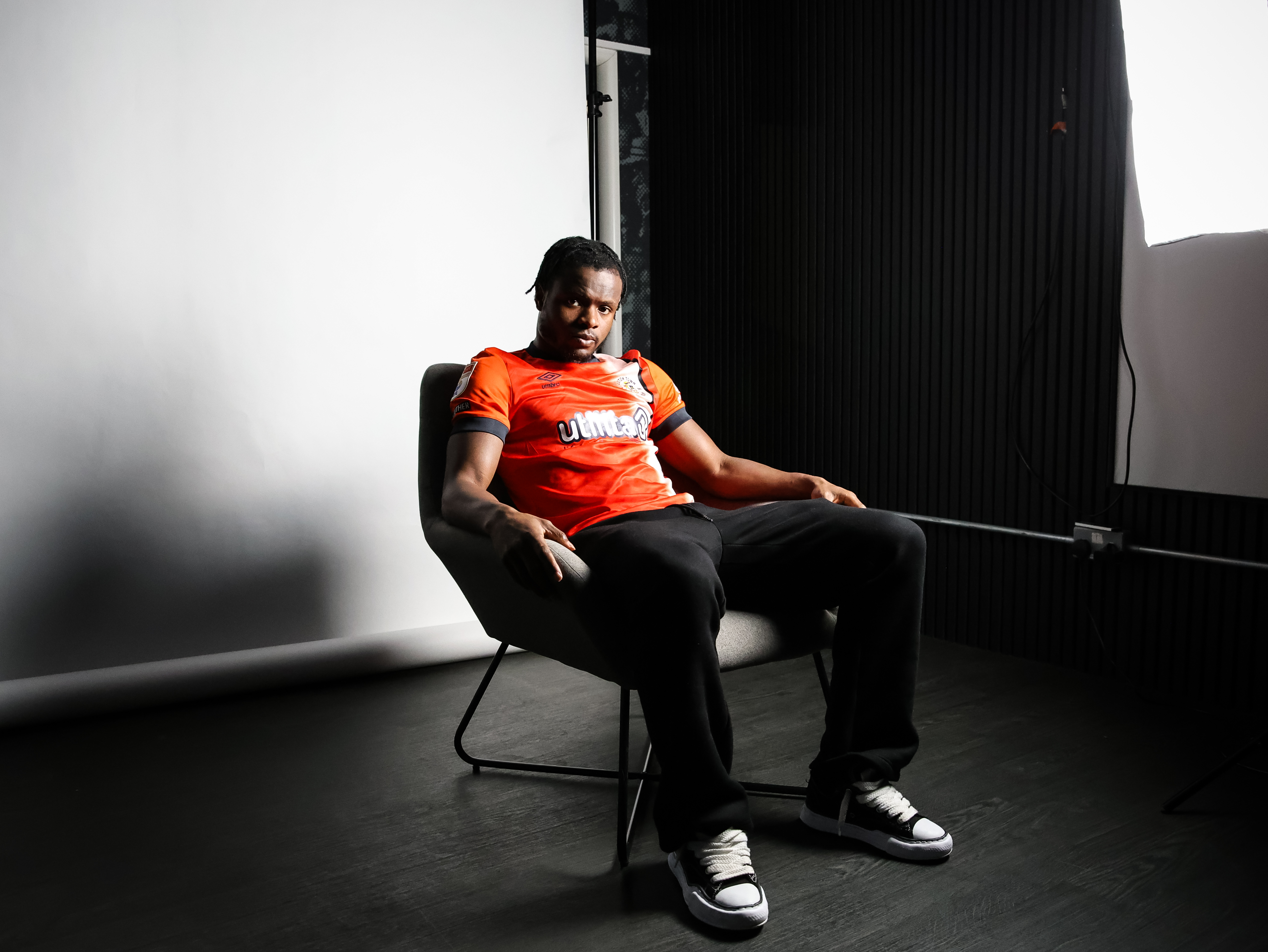 Milli Alli sat in a chair.