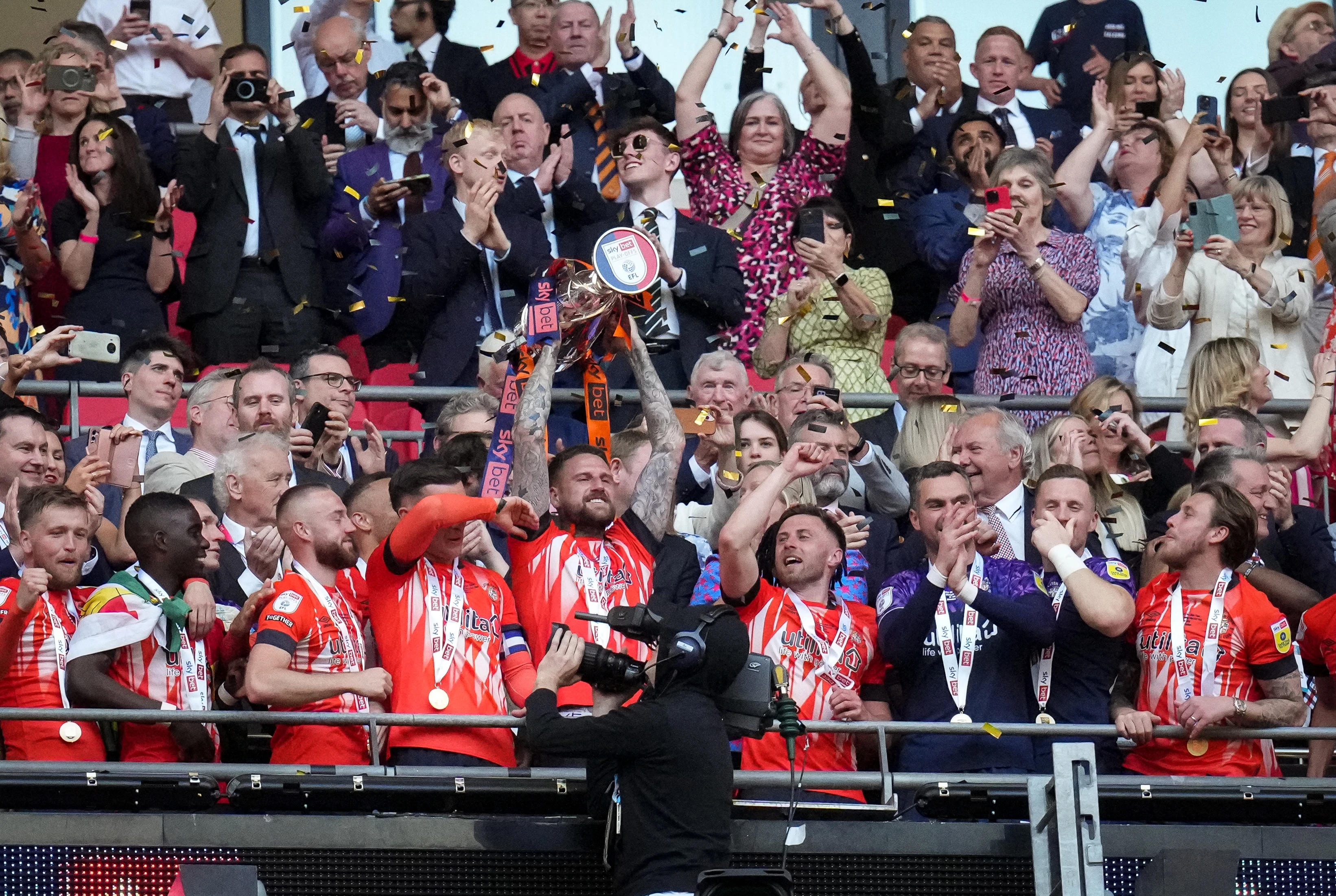 Club captain Sonny Bradley lifts the Championship play-off trophy aloft at Wembley in 2023