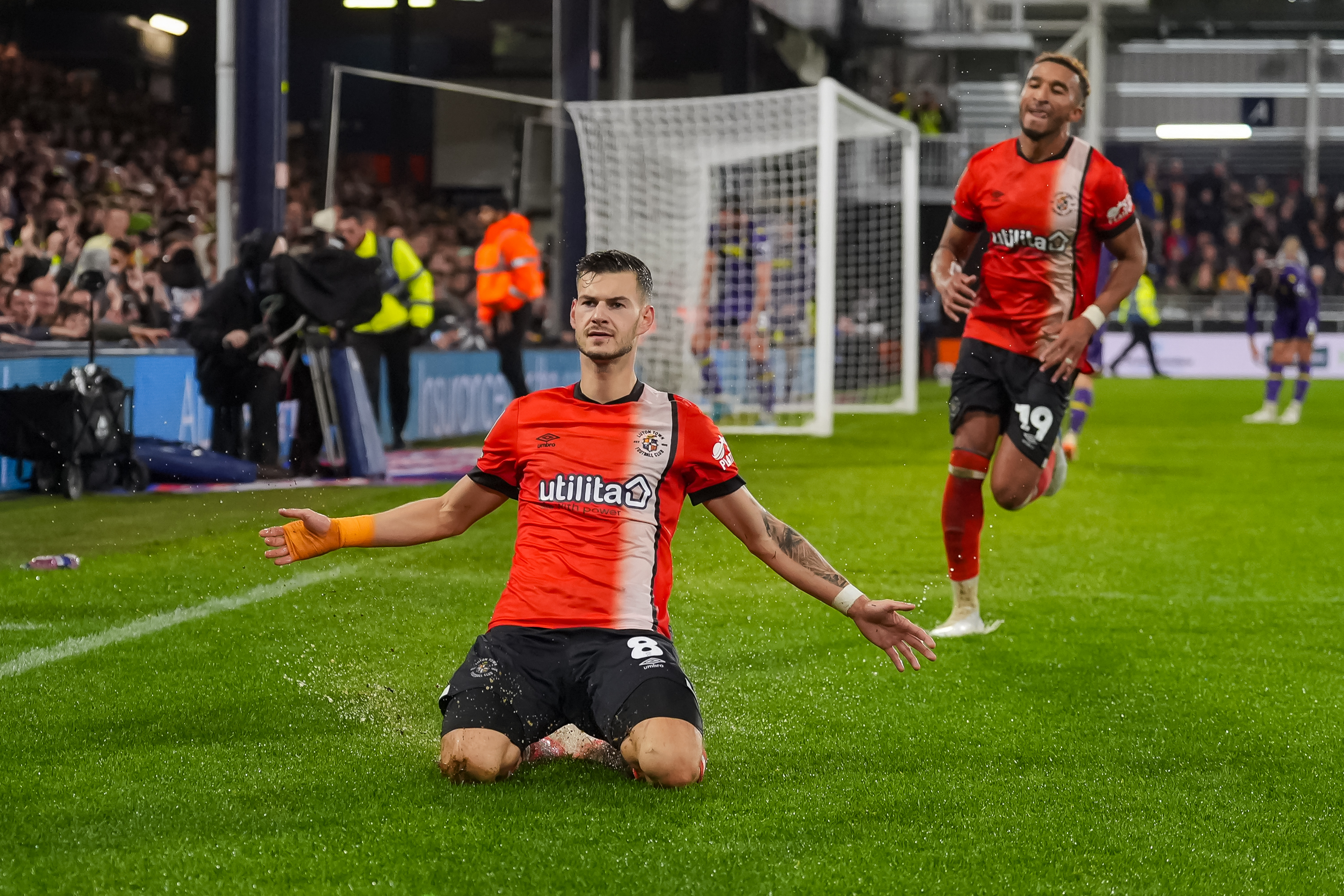 Tom Krauß slides on his knees in front of the Oak Road stand to celebrate his goal against Oxford at Kenilworth Road