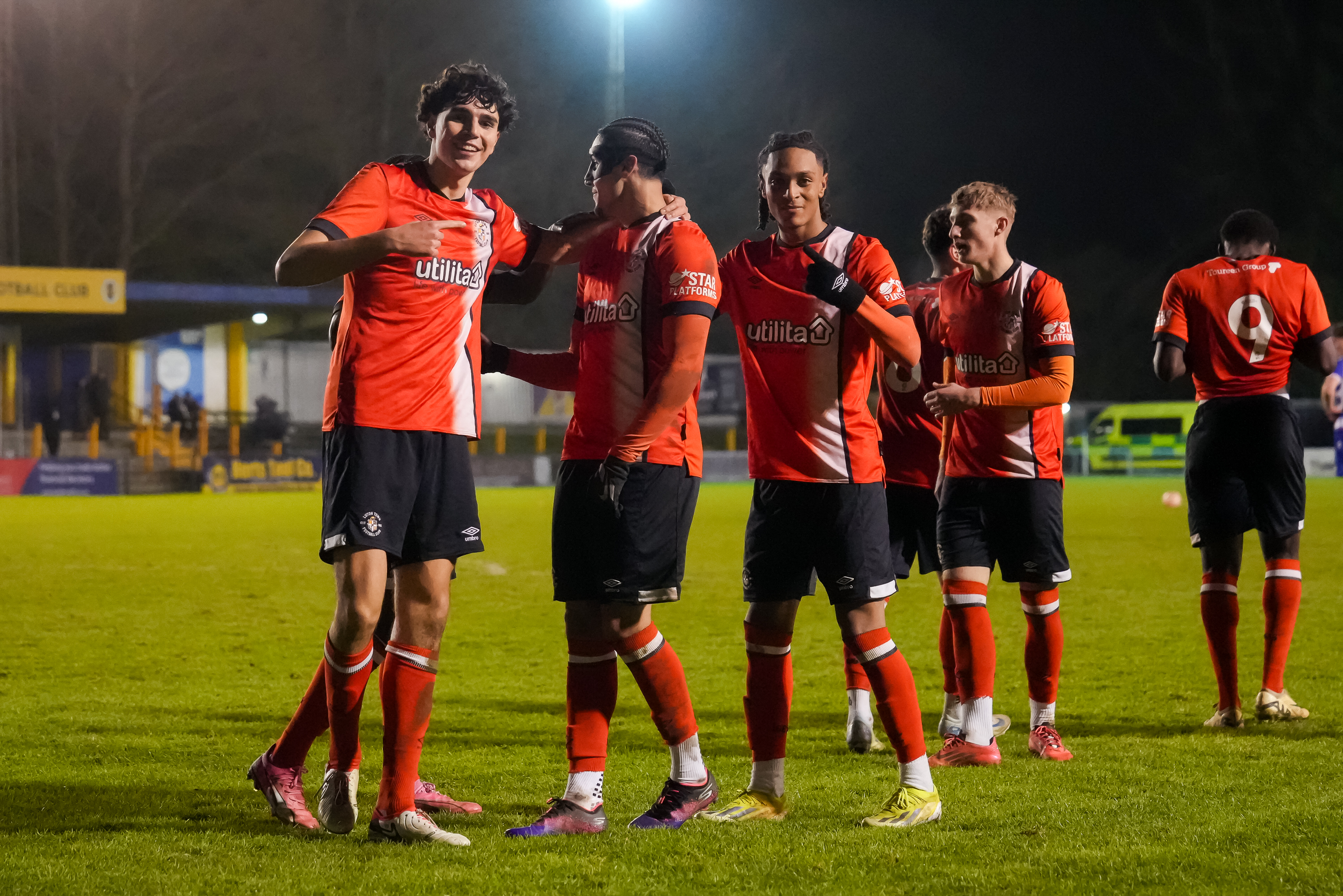 Town players Vladimir Paternoster, Taylan Harris and Josh Phillips celebrate Harris' goal in the 2-2 draw with Reading at St Albans City.