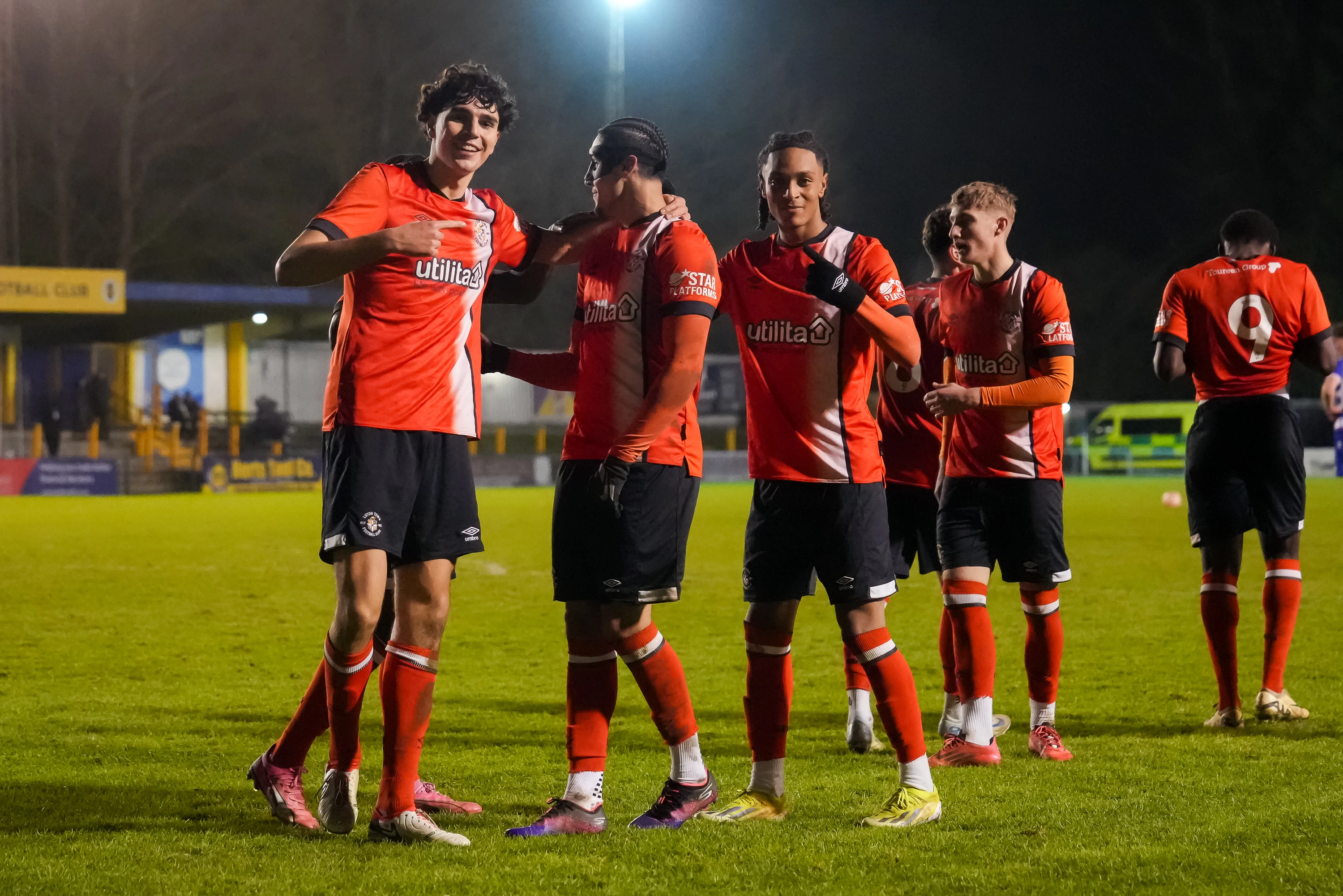 Town players Vladimir Paternoster, Taylan Harris and Josh Phillips celebrate Harris' goal in the 2-2 draw with Reading at St Albans City.