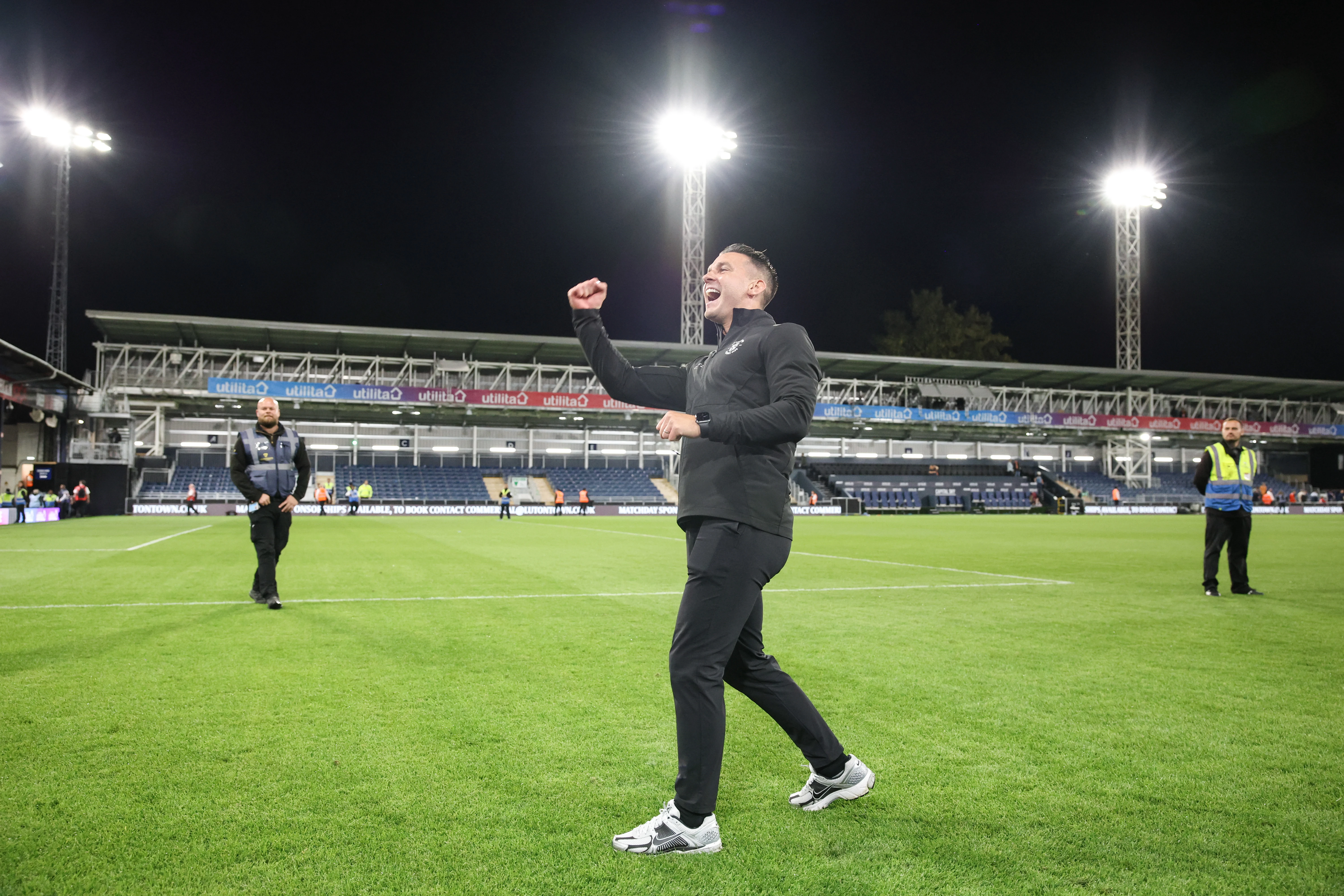 Matt Bloomfield fist pumping towards the Luton fans under the Kenilworth Road lights.