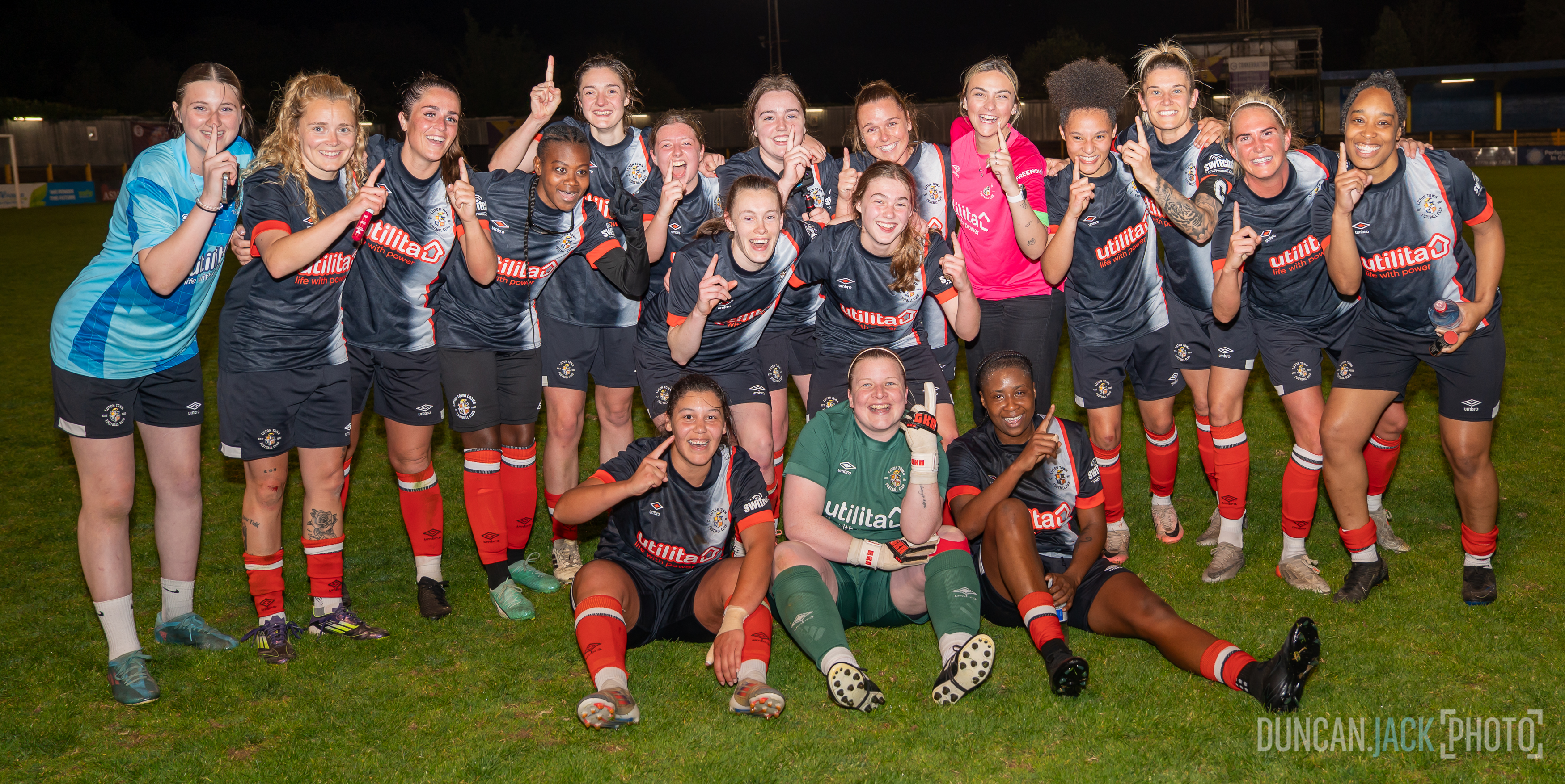 The Luton Ladies pointing their index finger in the air after winning the league at St Albans.