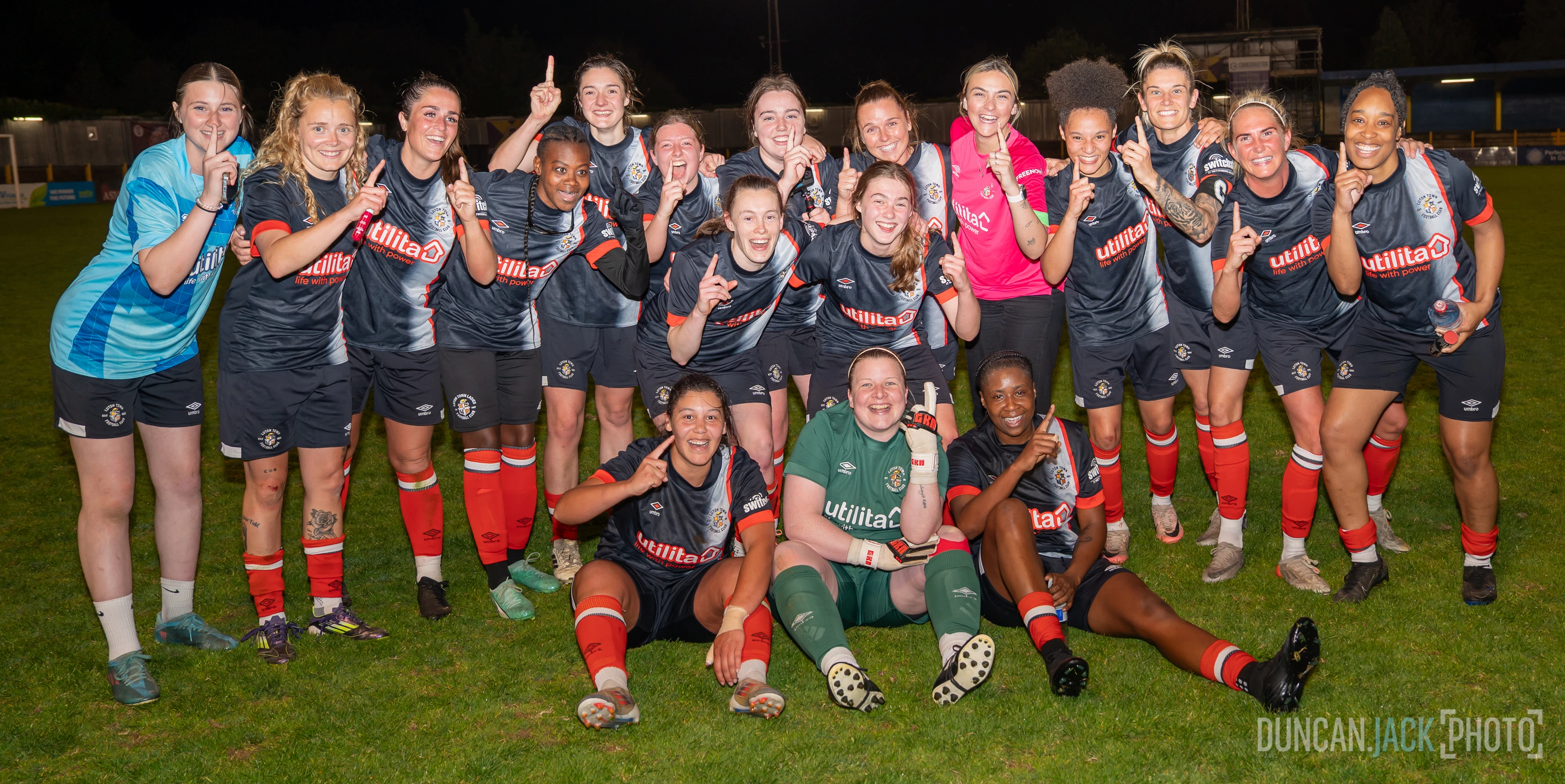 The Luton Ladies pointing their index finger in the air after winning the league at St Albans.