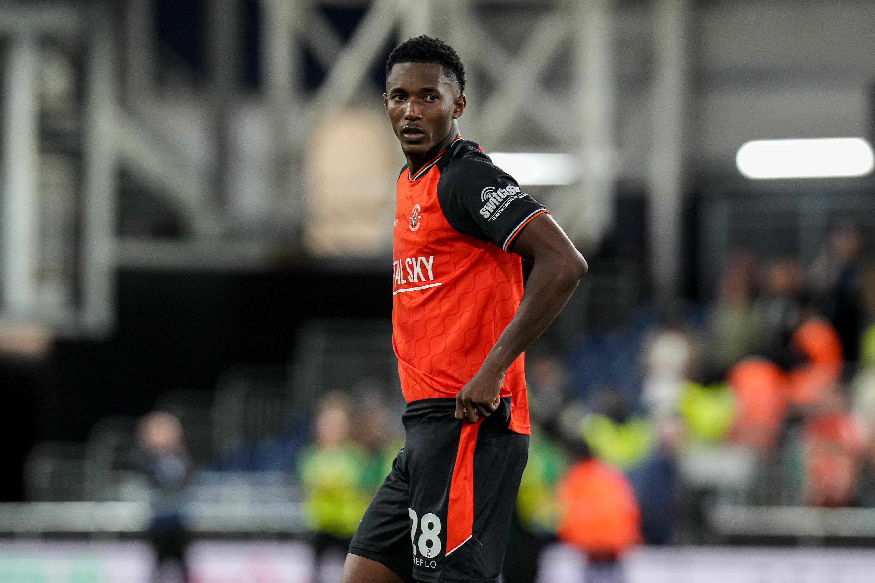 Christ Makosso pictured in action against AFC Wimbledon at Kenilworth Road.
