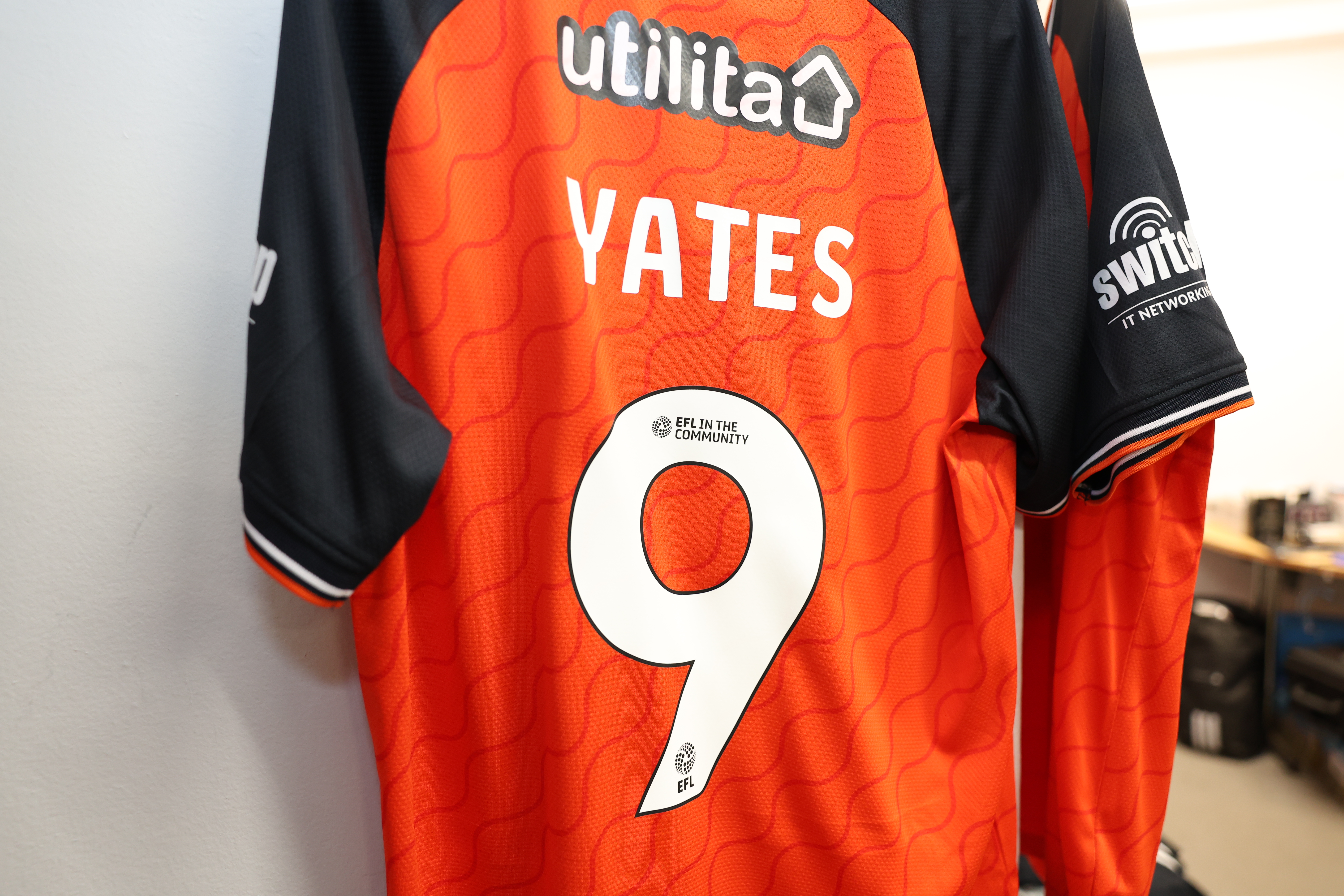 Jerry Yates' number nine shirt hangs in the away changing room at London Road.