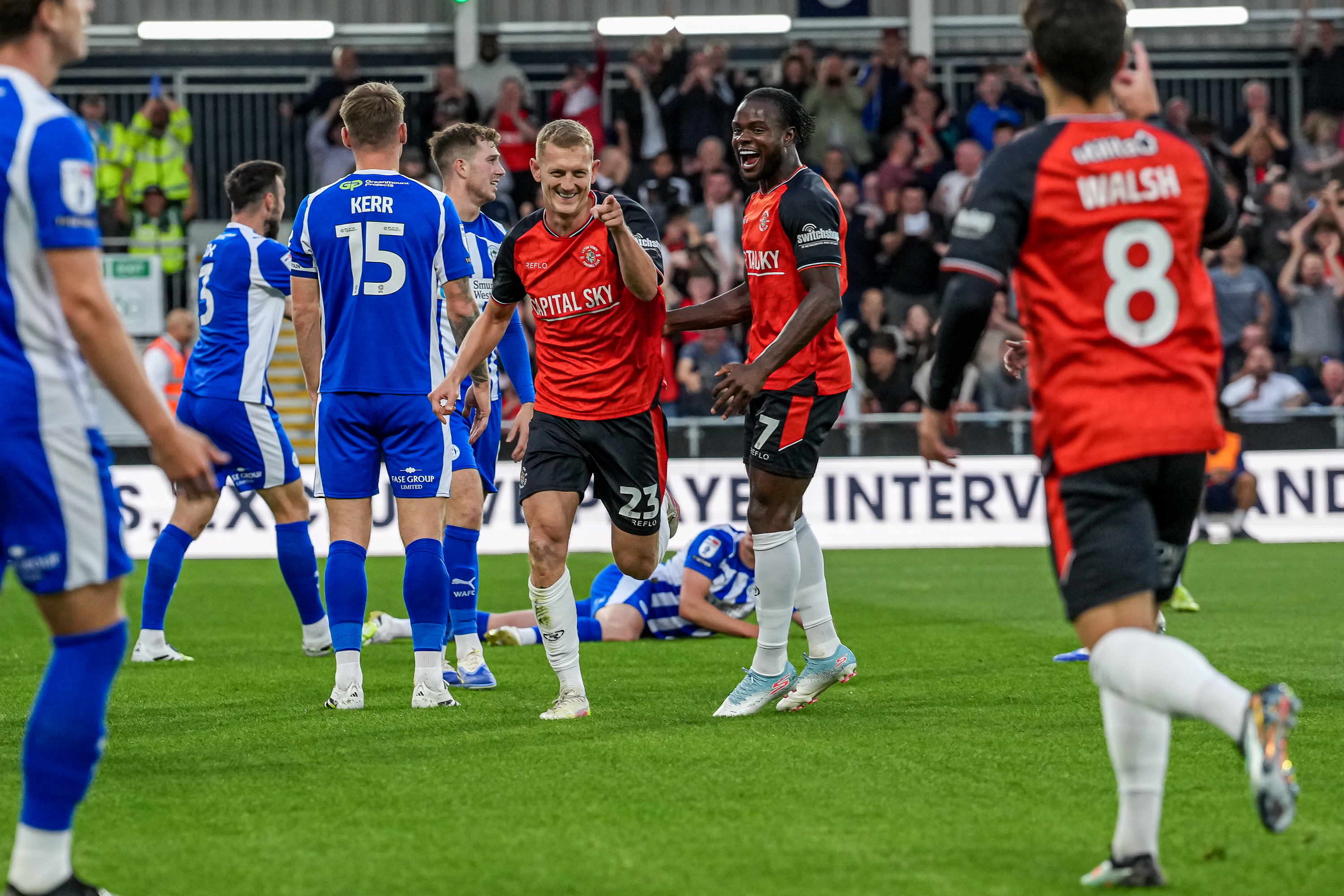 George Saville points towards Liam Walsh as he celebrates his winning goal against Wigan.