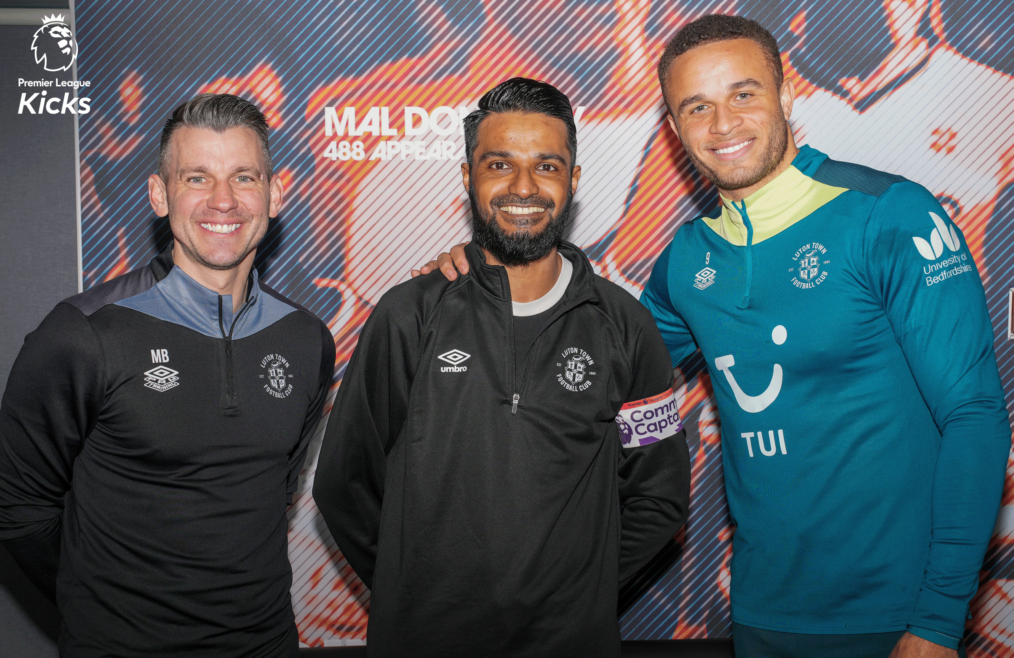 Luton Town Community Captain Shipaar Miah is presented with his Premier League Kicks armband by Town captain Carlton Morris and manager Matt Bloomfield