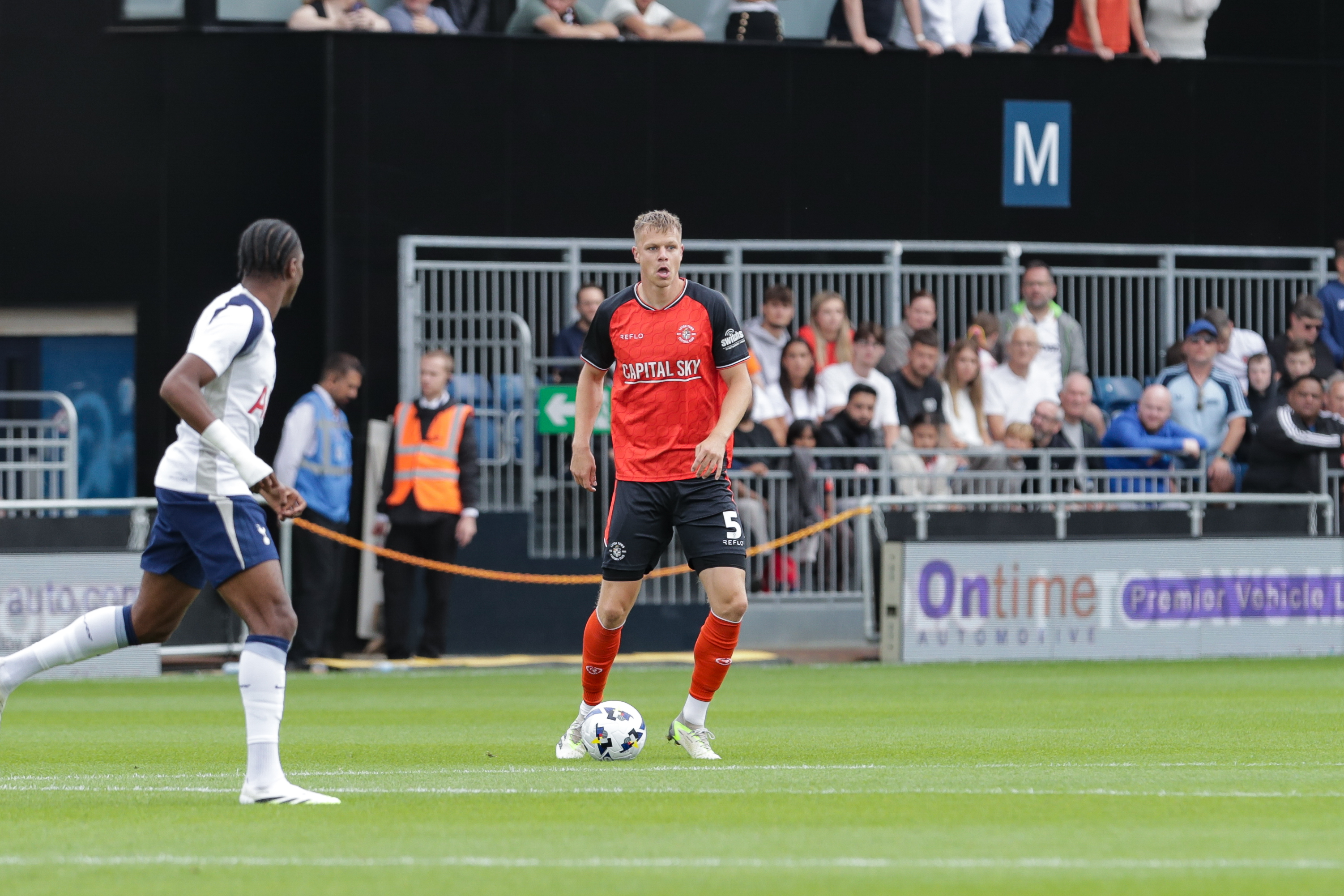 Mads Andersen in action at Kenilworth Road with the OnTime Automotive branding on the LED boards behind him.