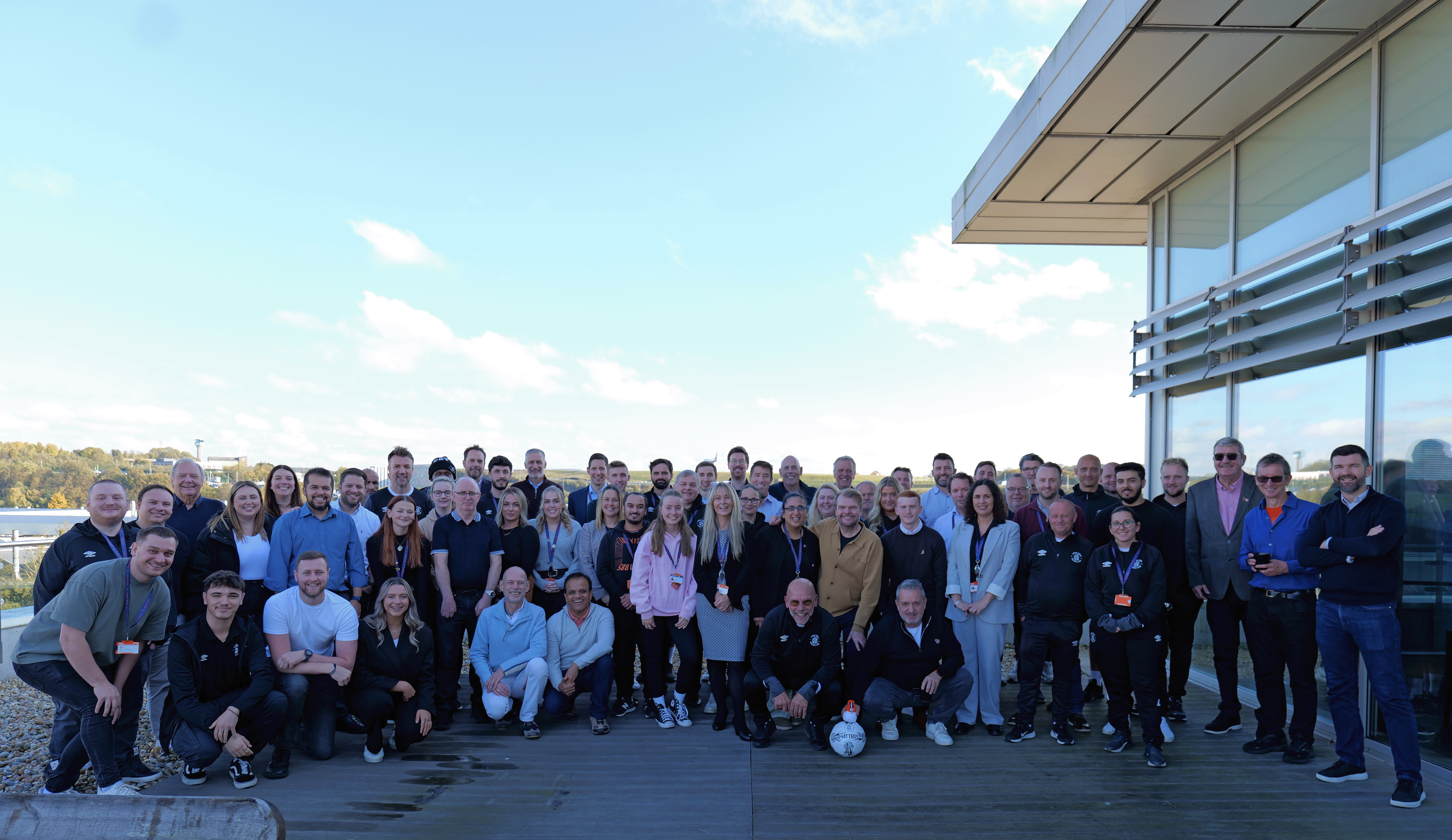 Our staff on a balcony at Luton HQ.