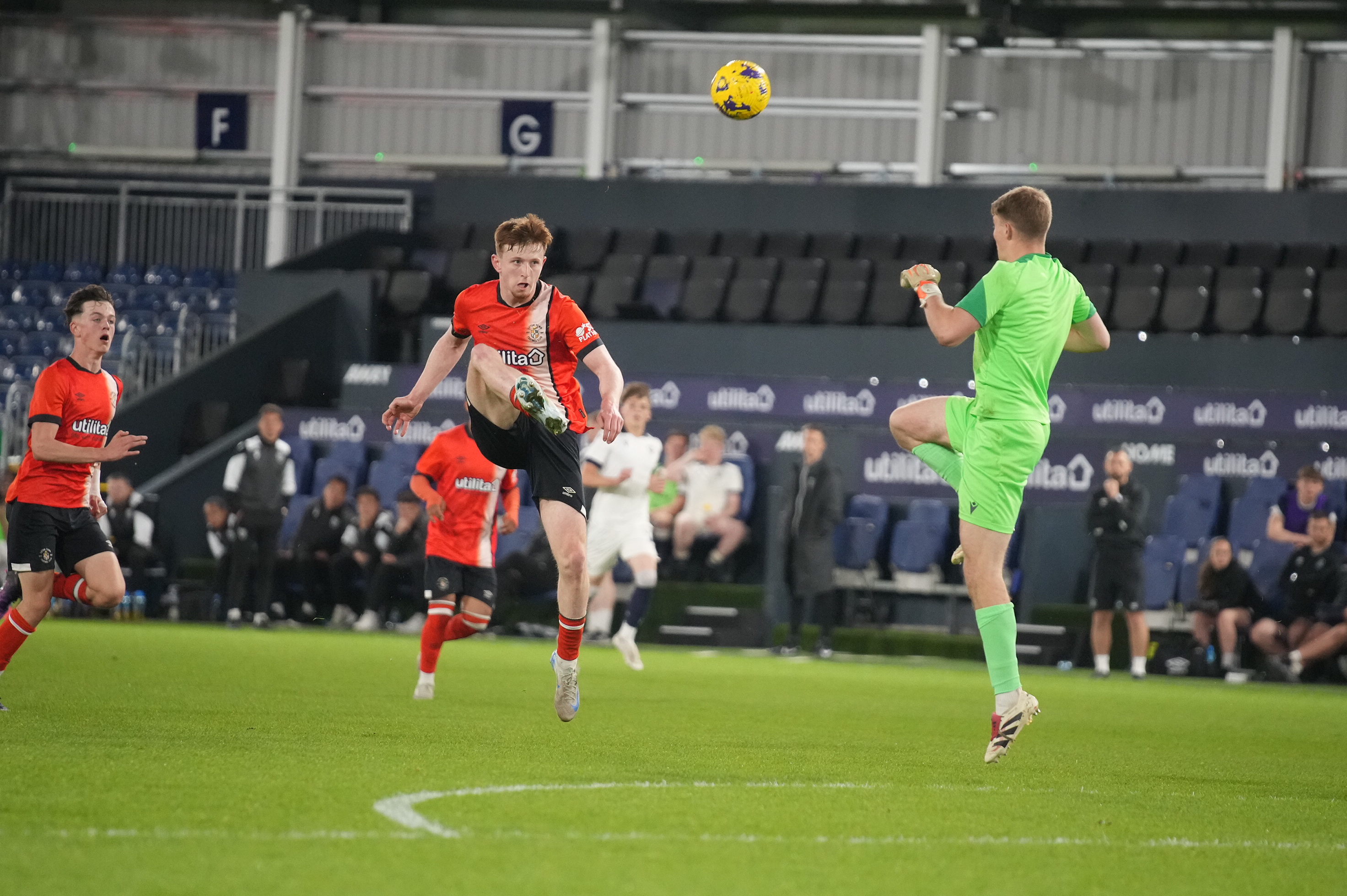 Oli Lynch lobs the Oxford keeper for the Hatters' equliser at Kenilworth Road.