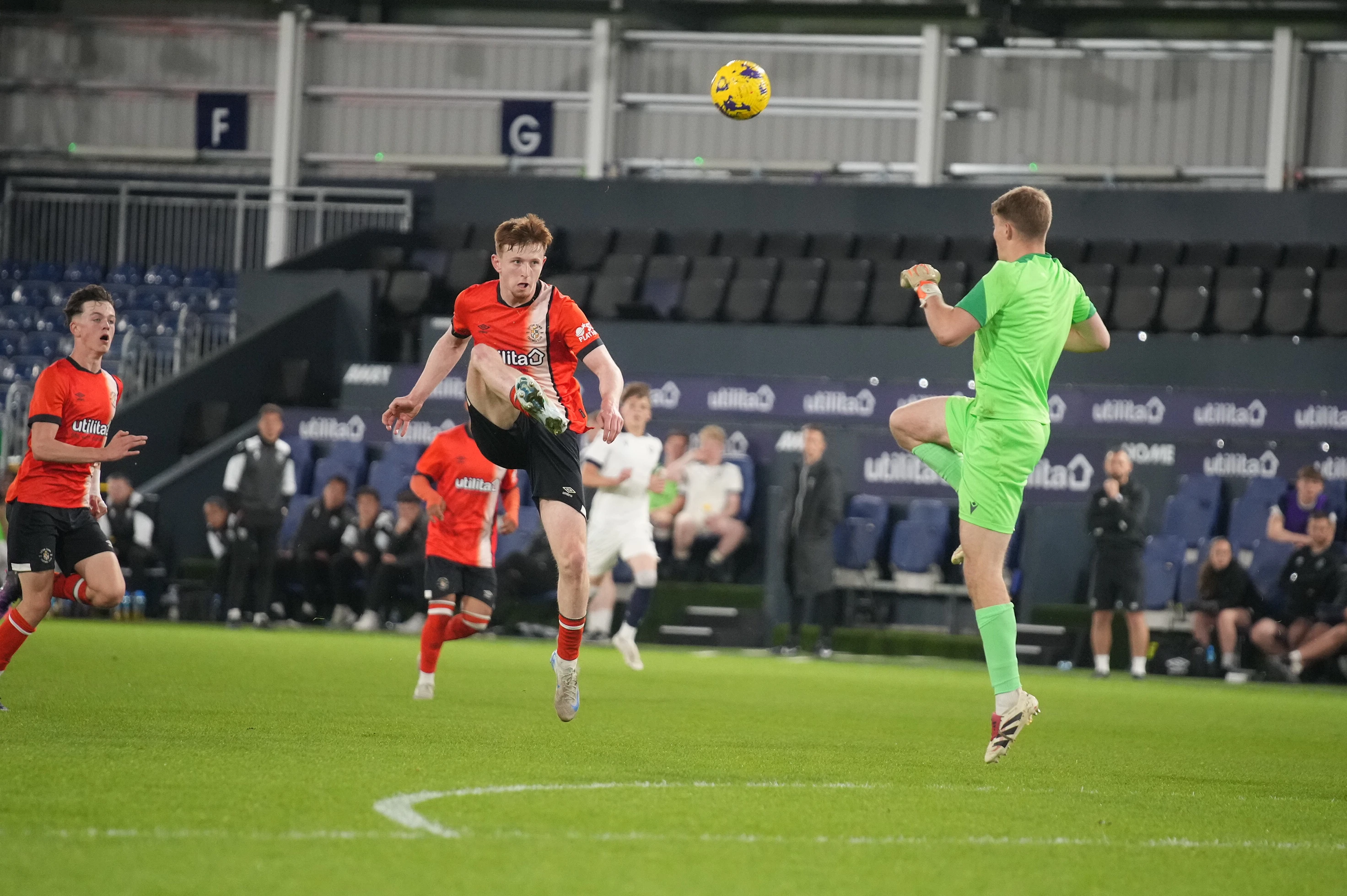 Oli Lynch lobs the Oxford keeper for the Hatters' equliser at Kenilworth Road.