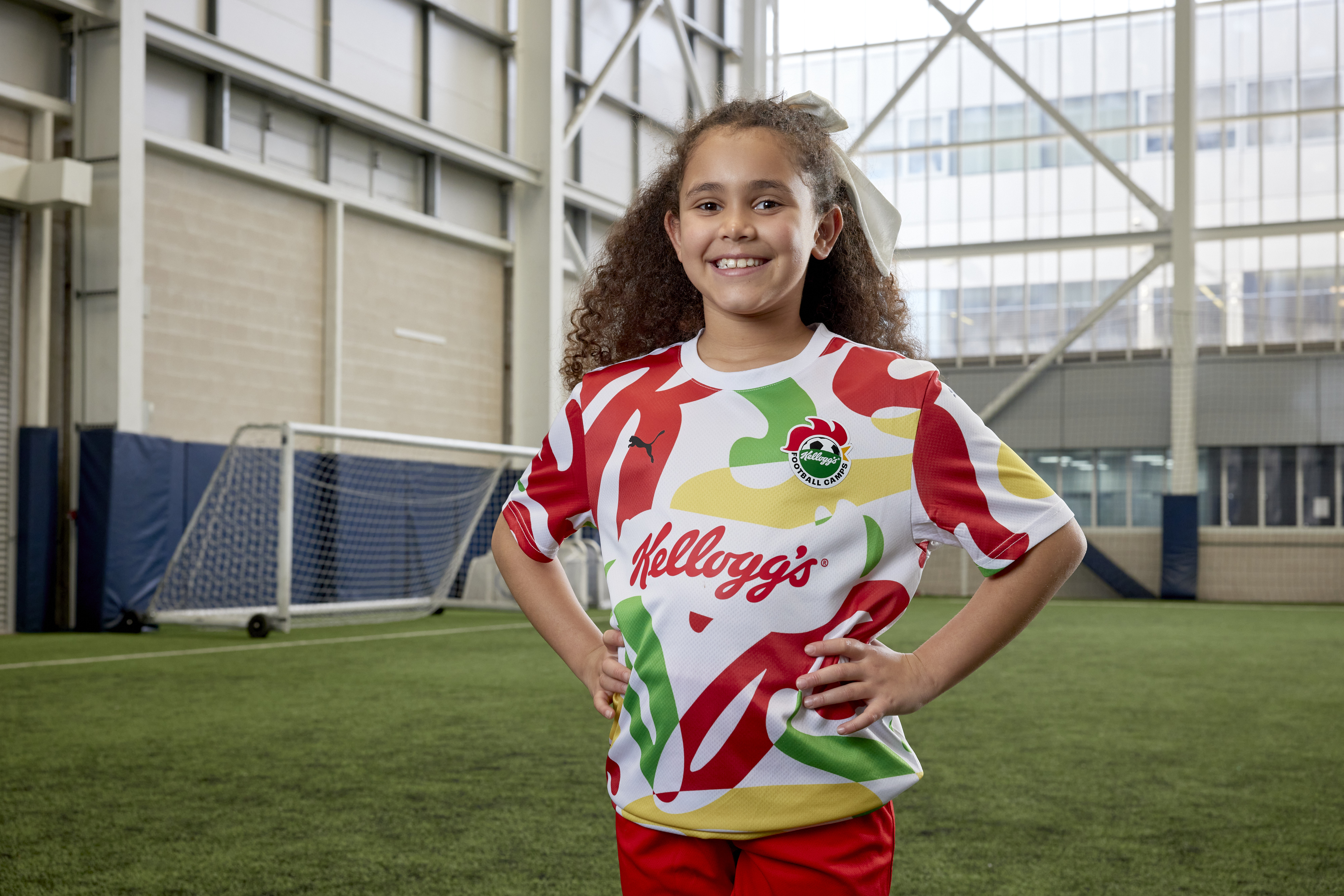 A stock image of a child wearing a Kellogg's football shirt at one of their soccer camps.