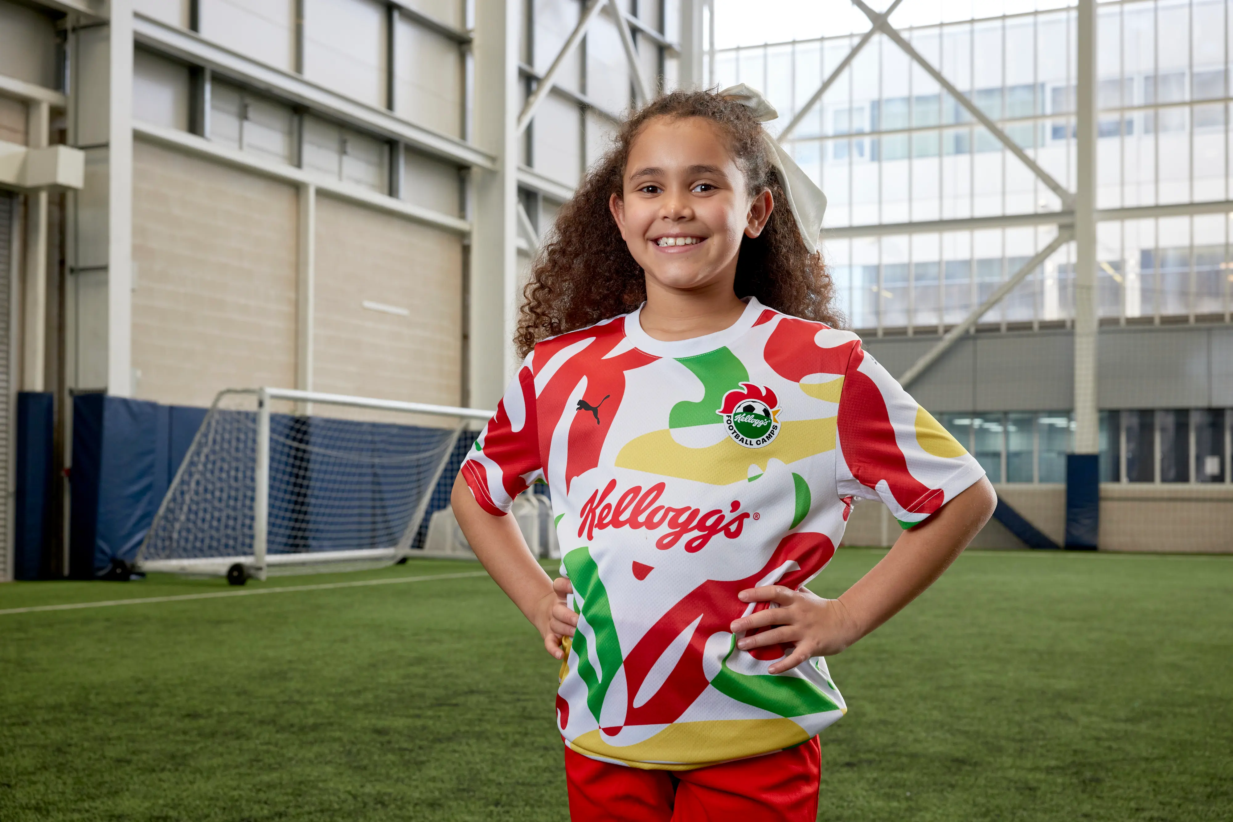 A stock image of a child wearing a Kellogg's football shirt at one of their soccer camps.