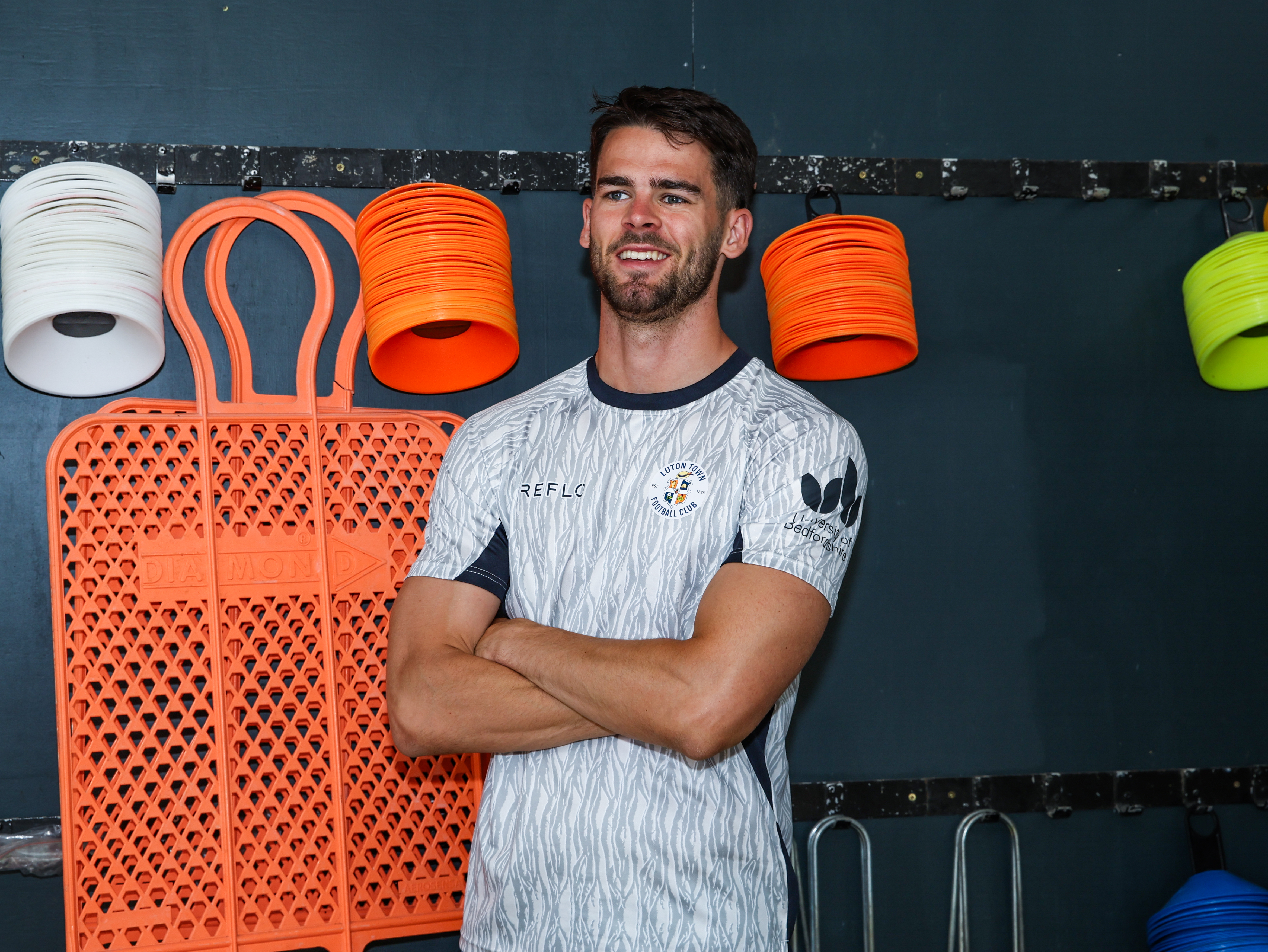 Lasse Nordas wears the new matchday training shirt in the equipment store at The Brache.