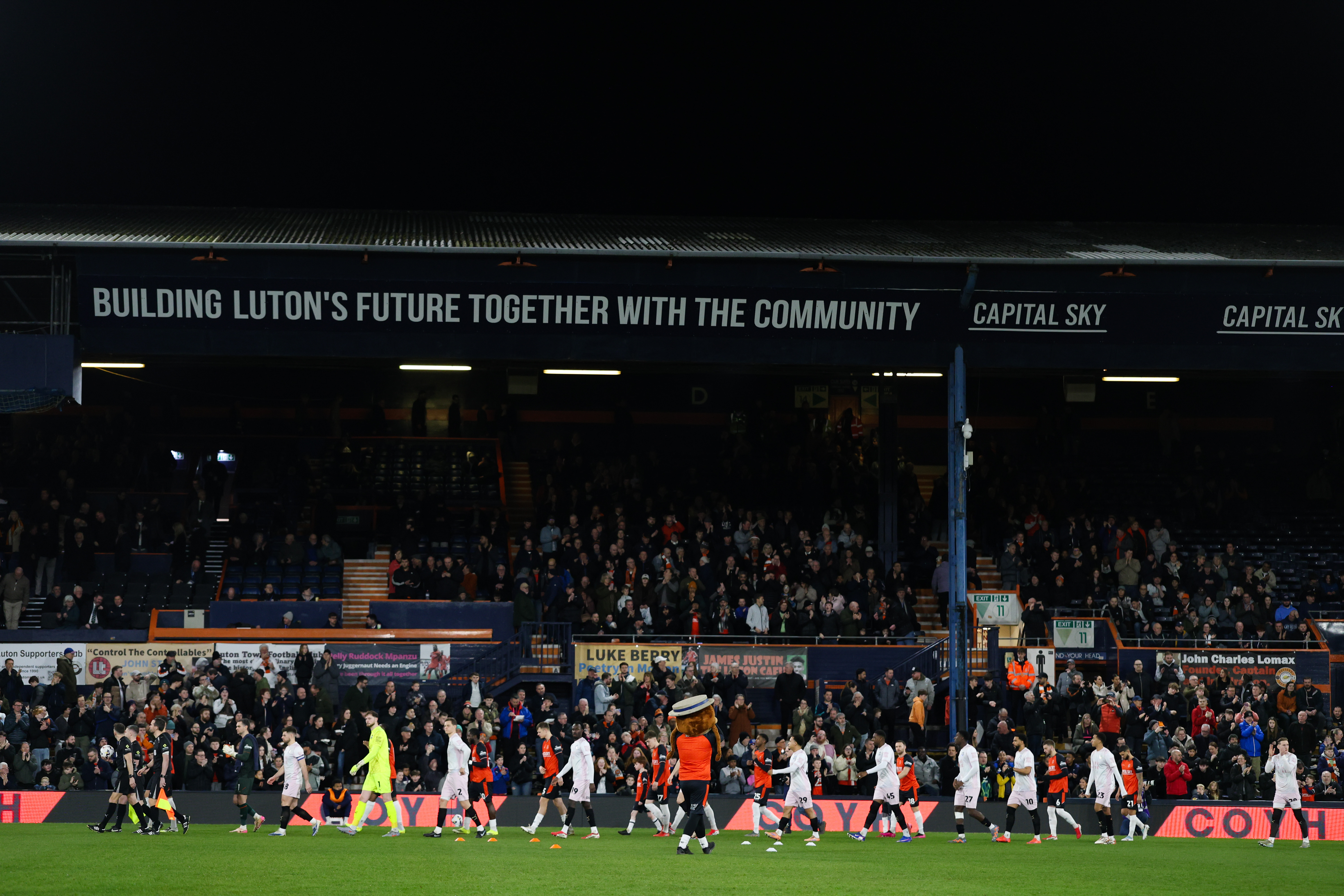 Luton Town and Plymouth Argyle players take to the Kenilworth Road pitch in front of the Main Stand ahead of the Vertu Trophy quarter-final.