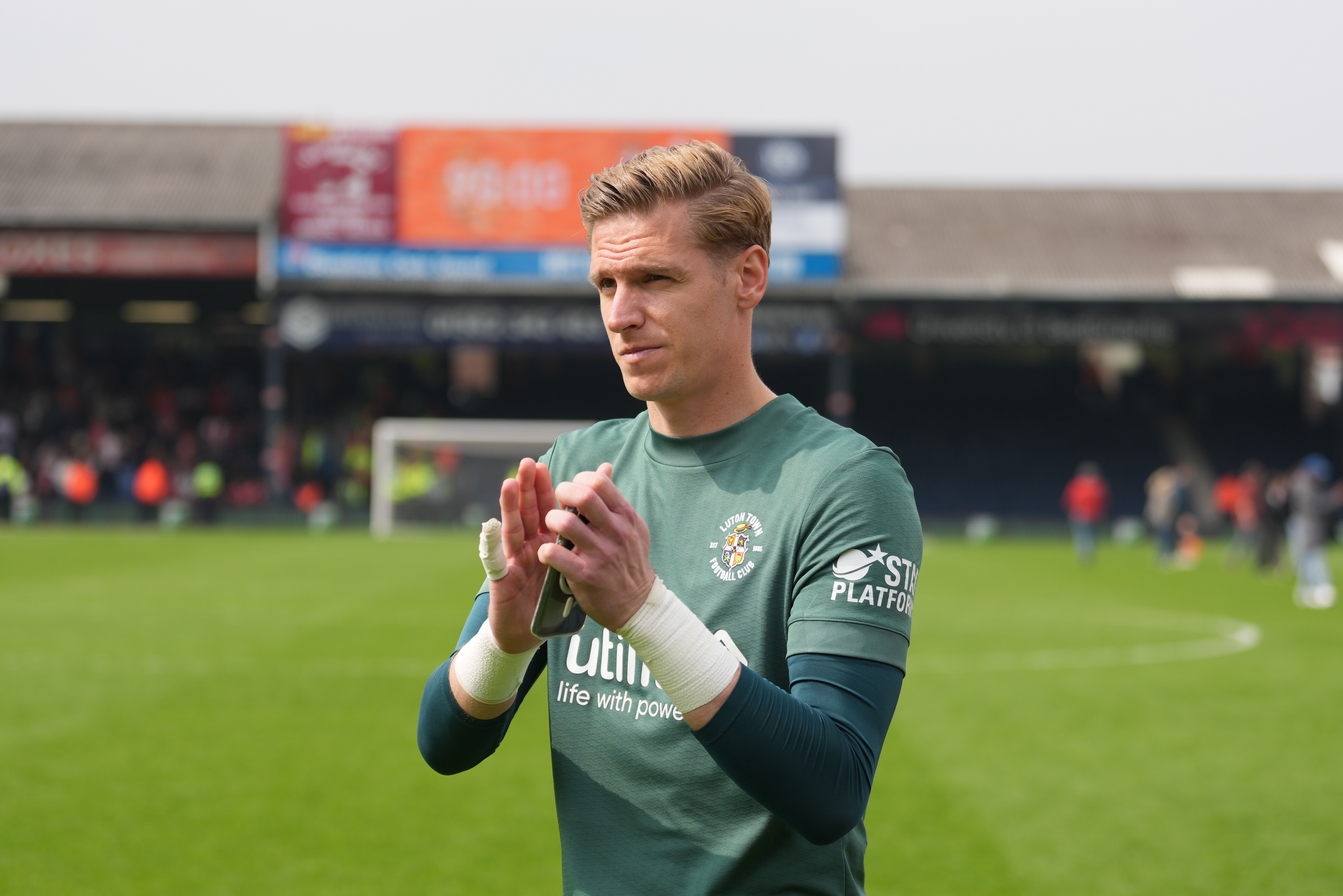 Thomas Kaminski applauds supporters at the end of 1-0 win over Coventry City at Kenilworth Road.