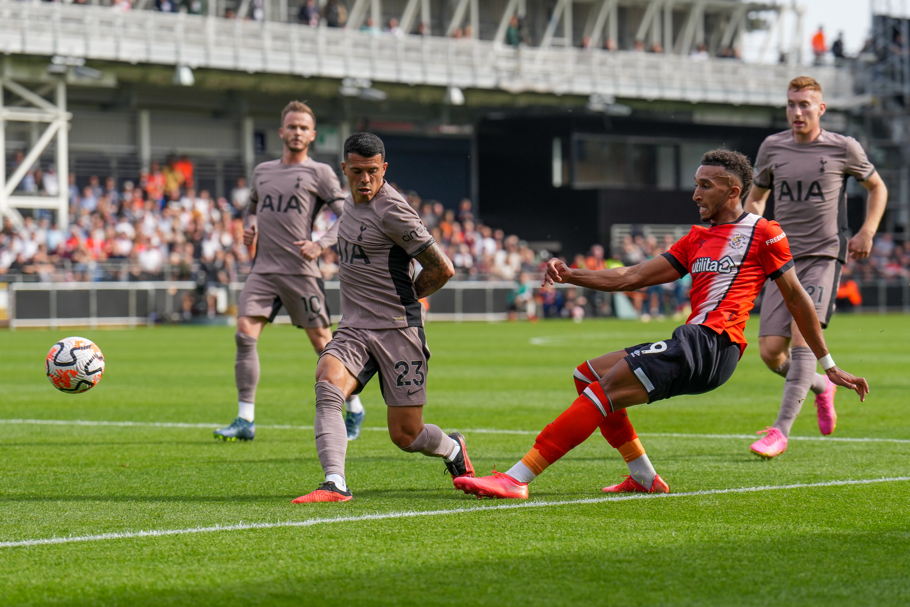 Jacob Brown gets a cross in ahead of Tottenham defender Pedro Porro when Spurs last visited Kenilworth Road in October 2023.
