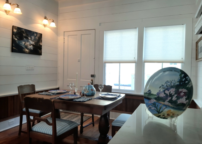 Cute dining room next to the open kitchen with natural light and access to the back outdoor balcony