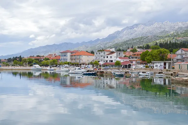 Starigrad Paklenica waterfront with calm sea and mountain Velebit at background