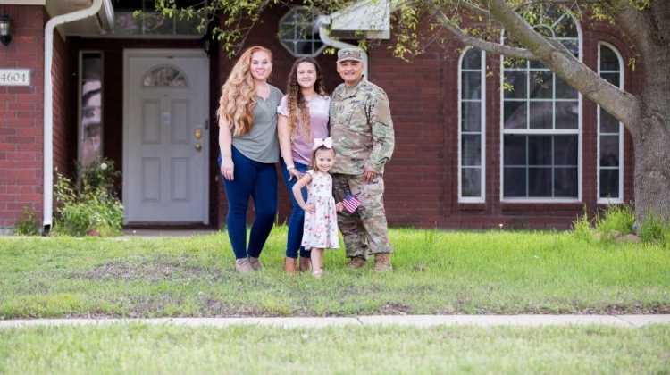 miitary family in front of home