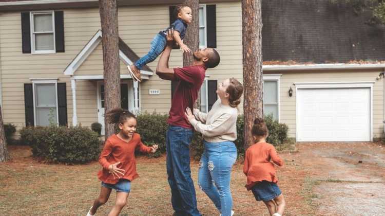 Family of 5 playing together outside their home