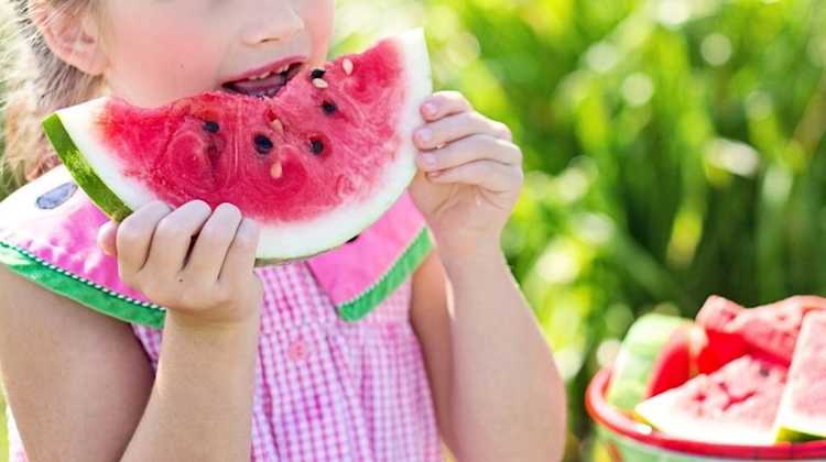 child eating watermelon