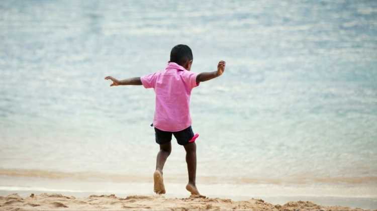 child playing at the beach