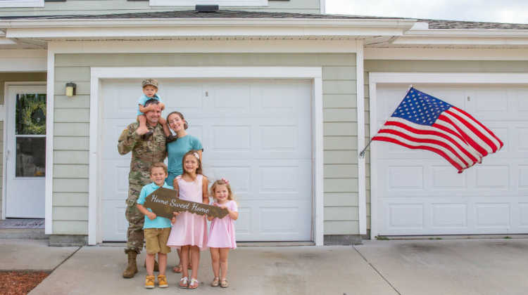 military family in front of home