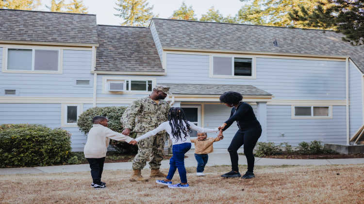 military family in front of a home, showing resilience during PCS moves
