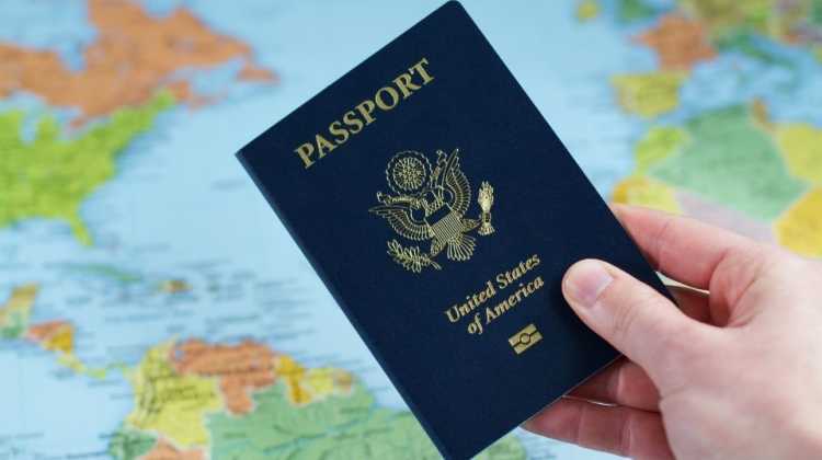passport held in front of global map
