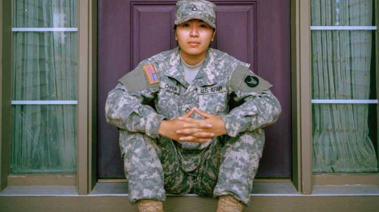 soldier sitting in front of door