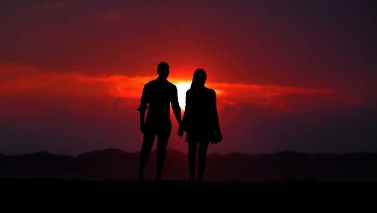 military couple holds hands during sunset on a date night near Fort Bliss in El Paso, Texas