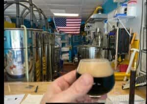 hand holding beer glass at Split Fin Brewery near Fort Stewart, Georgia